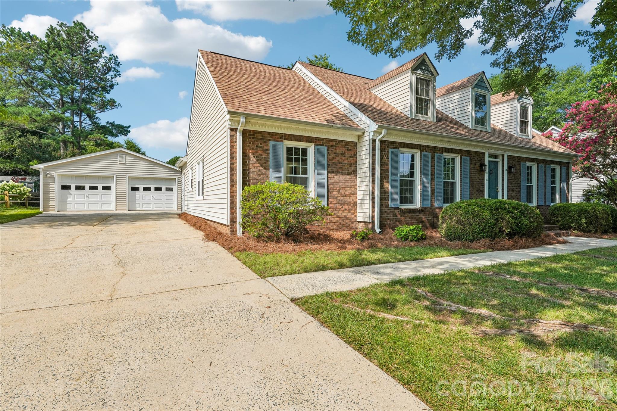 Welcome to Parks Farm Lane in the highly desirable Raeburn community, ideally located just minutes from shopping, dining, and entertainment in South Charlotte and Ballantyne.

This well-maintained four-bedroom, two-and-a-half-bath home offers a versatile floor plan with a sought-after main-level primary suite. A second bedroom on the main floor provides the perfect space for a home office, guest room, or nursery, while two additional bedrooms and a full bath upstairs create privacy for family or visitors. An unfinished walk-in attic offers abundant storage or future expansion potential.

Inside, you'll find multiple living spaces designed for both everyday living and entertaining. The welcoming foyer opens to a formal living room and dining room, leading to the spacious kitchen with breakfast nook. Just beyond, the cozy family room with fireplace overlooks the backyard, creating a comfortable gathering space for family and friends.

Step outside to enjoy the large patio and level backyard, perfect for outdoor entertaining, gardening, or simply relaxing. The detached two-car garage provides additional storage and parking while enhancing the home's curb appeal.

Conveniently situated on the same side of Rae Road as Raeburn's outstanding amenities, residents enjoy easy access to the community pool, tennis courts, and playground nearby via a walking trail at the end of Ducksbill Drive.

Offering an ideal combination of space, flexibility, and an unbeatable location, this home is ready for its next owner.