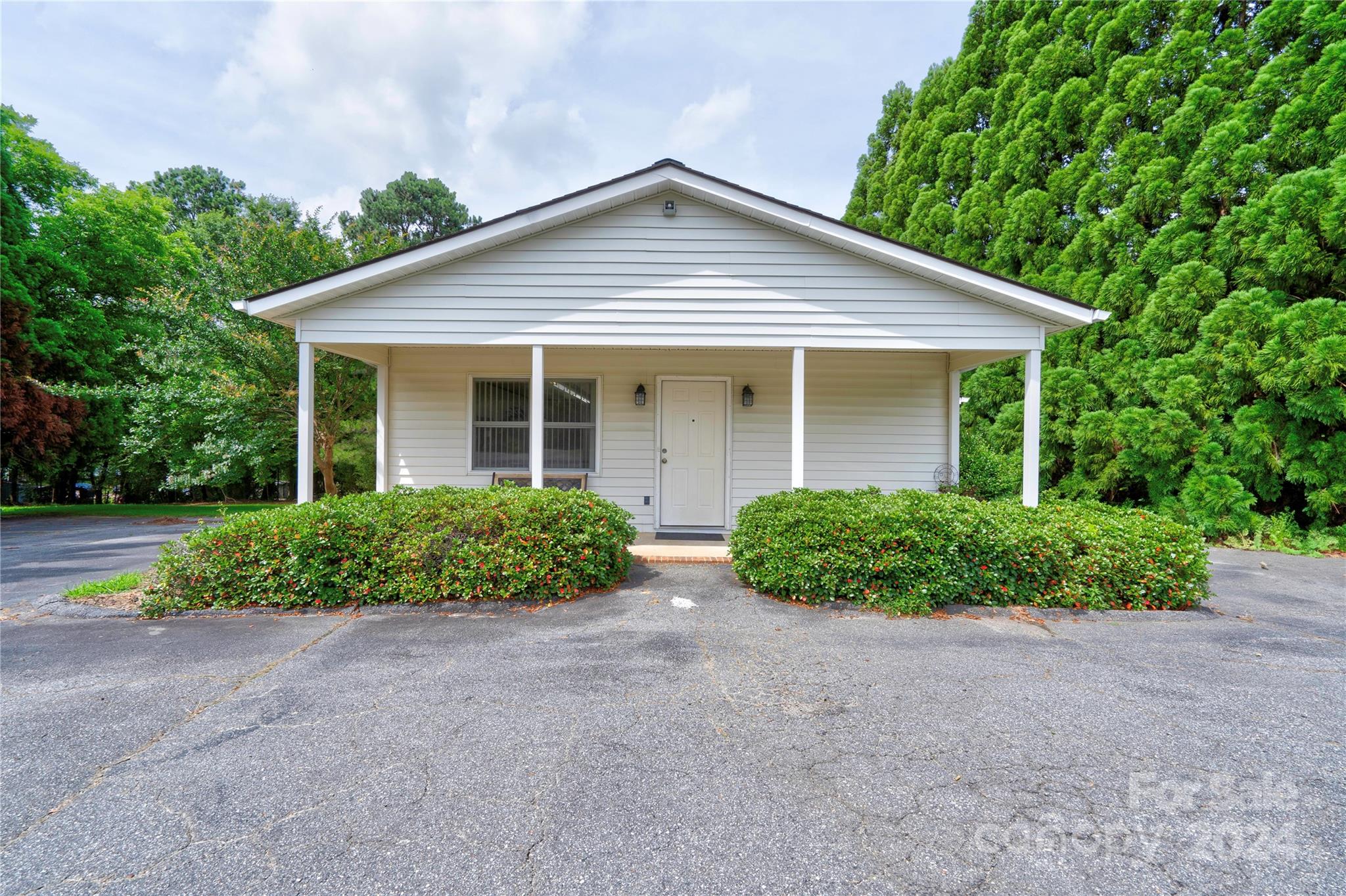 Well established beauty shop includes 5 workstations, 3 wash stations, open floor plan, waiting area, 2 restrooms, kitchenette, covered rocking chair front porch, tall crawl space for storage, approximately 15 paved parking spaces, washer/dryer and refrigerator included.   Great business opportunity! Call today to schedule a showing!