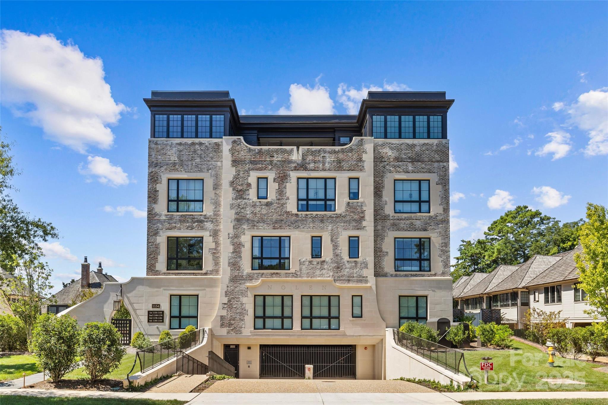 Exquisite 3BR, 3.5BA residence in The Nolen on Queens Road, one of Charlotte’s most exclusive luxury condo buildings. Completed in 2024, this boutique 17-unit development was thoughtfully designed by Ken Pursley, developed by Brian Speas, and offers refined living in the heart of Myers Park. Spanning apx 2500 square feet, this light-filled unit boasts soaring 10’ ceilings, hardwood floors, automatic window coverings, and designer lighting and finishes throughout. The open layout features a family room with limestone gas fireplace and dining room that opens to a covered terrace with bluestone pavers and built-in gas grill. The Chef’s kitchen stuns with custom cabinetry, white marble countertops, wine display wall, Wolf gas range, paneled SubZero refrigerator, and incredible scullery. A gorgeous walnut-paneled study with custom built-ins and full en-suite bath offers flexibility as a 3rd bedroom. The Primary suite includes terrace access, an expansive walk-in closet, and spa-like bath with dual marble vanities, soaking tub, and frameless glass shower. Secure gated entry, two deeded parking spots, storage, and elegant common areas make this a rare offering on tree-lined Queens Road!