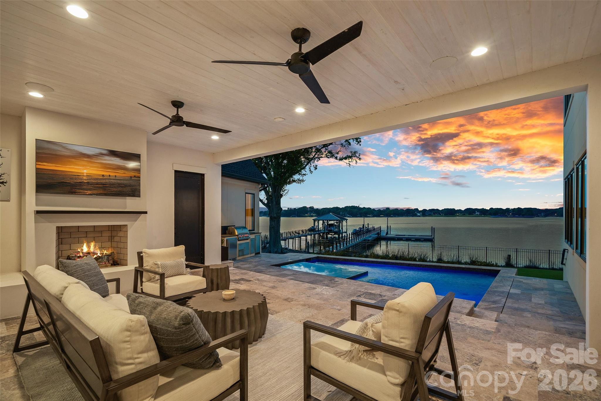 A rare offering on Lake Norman, this gated waterfront estate captures breathtaking unobstructed long range views across the lake. Perfectly positioned in the heart of Cornelius, the residence was thoughtfully designed to maximize the water from nearly every primary living space while delivering a level of luxury and privacy seldom found in today's market.
Beyond the gas-lit courtyard, the lake serves as the centerpiece of the home, showcased through walls of glass that capture panoramic water views from nearly every vantage point. Soaring 10-foot ceilings, wide-plank white oak flooring, and designer finishes create an atmosphere of understated luxury. The gourmet chef's kitchen serves as the heart of the home, anchored by a grand island, Wolf 8-burner range with double oven, scullery, wine room, planning center, and bespoke Miele coffee bar. Seamless indoor-outdoor living connects the dining and great room spaces to a covered lakeside lanai with fireplace, built-in grill, dedicated pool bath, heated pool, and spa, all overlooking the expansive water beyond.
The main-level primary retreat offers a private sanctuary with tranquil lake views, separate vanities, an oversized tiled shower, soaking tub, his-and-her closets, and private laundry. An executive office, planning center, built-in drop zone, and thoughtfully integrated storage further enhance the home's functionality without compromising its elegance.
Upstairs, a spacious family lounge overlooking the water, flex room, built-in study station, and three ensuite bedrooms with walk-in closets provide exceptional comfort and privacy. A breezeway leads to a private second living quarters complete with a kitchenette, full bath, balcony, and flexible living space currently utilized as a fitness studio.
The outdoor experience is equally remarkable. A modernized 150-foot grandfathered pier extends into the lake and leads to an upgraded floating dock featuring lighting, water service, and 240V electrical. Whether hosting guests poolside, enjoying a sunset cruise, or simply taking in the ever-changing views across the water, the setting is extraordinary.
With no HOA, private gated entry, and a premier Cornelius location, this exceptional waterfront estate represents a rare opportunity to own a truly irreplaceable piece of Lake Norman, where breathtaking views, thoughtful design, and resort-inspired living come together in remarkable fashion.