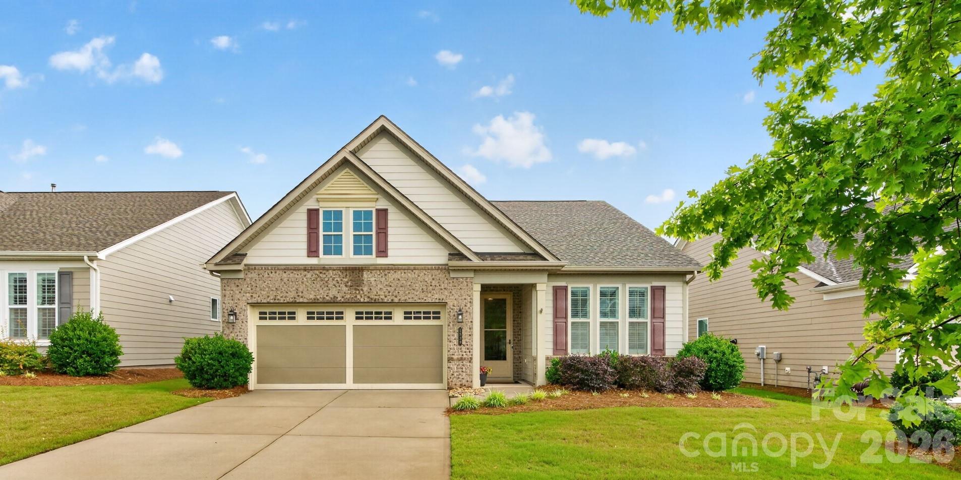 Step into a new rhythm of life. This single-story Cresswind Charlotte ranch is move-in ready, maintenance-free, and genuinely beautiful to come home to. 

A gas fireplace anchors the open living room. The kitchen wraps around a central island with a gas cooktop and dedicated pantry. The primary suite is private and calm, with dual closets and a zero-entry shower designed for ease today and freedom for years to come. The rear screened porch looks out to a canopy of mature trees. Stillness on demand.

Grocery shopping, restaurants, and medical services are within walking distance or a golf cart ride away. The HOA covers lawn care, security monitoring, cable, and internet. The 18,000-square-foot amenity center delivers an indoor lap pool, resort-style outdoor pool, spa, fitness center, yoga room, pickleball, tennis, bocce, wooded trails, demo kitchen, arts room, and dog park. A full-time Lifestyle Director coordinates events, clubs, and activities year-round.  This is Cresswind resort-style 55+ living in Charlotte. See it, make it yours.

Built in 2019 by Kolter Homes, the Ashford model delivers 1,586 square feet of single-level living on a slab foundation with fiber cement exterior. Ten-foot ceilings and eight-foot doors throughout. Plantation shutters and 2" faux blinds cover the windows. A navy accent wall frames the gas fireplace with light surround. Easy care wide plank vinyl flooring runs through the main living areas. Updated fans and light fixtures throughout.

The kitchen is equipped with a gas cooktop, electric oven, dishwasher, microwave, and refrigerator with ice maker. The laundry room is separate with a utility sink. In-ground irrigation draws from the community pond with no additional water bill. The attached two-car garage includes pull-down attic storage.

The primary bath features a double vanity with white cabinetry and dark granite countertops. The large tile zero entry shower has a glass enclosure, tile niche, bench, and side mounted controls. The screened porch has a concrete floor and framed screen panels with a door to the backyard. Mature trees line the rear property providing a natural privacy buffer.

All major systems are 2019. Roof, HVAC, and water heater are all under seven years old. Nothing to replace. Nothing to worry about.

Cresswind Charlotte is a 55+ master-planned community. HOA fee is $400 per month and includes full access to all community amenities, complete lawn care maintenance, in-home security system with monitoring, basic cable television, and high-speed wireless internet.

Uptown Charlotte is a short drive for world-class dining, arts, and entertainment. Charlotte Douglas International Airport is close for those who love to travel.