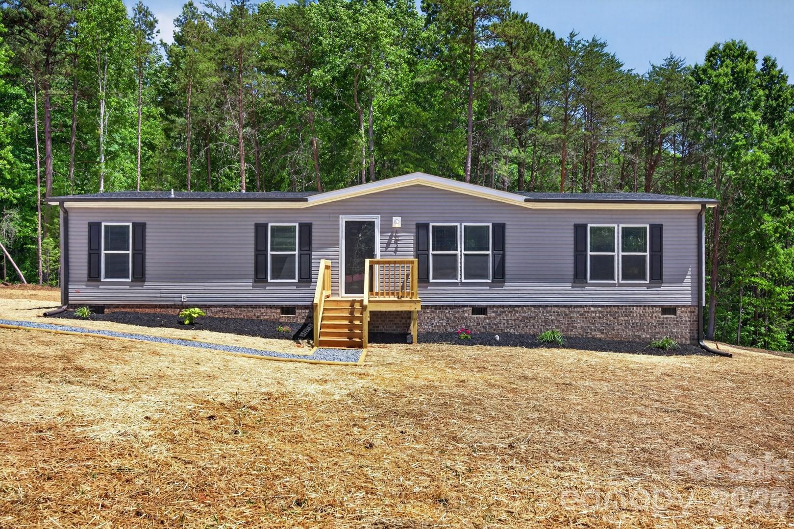 Brand-new 3-bedroom, 2-bath home situated on 3/4 of an acre, offering modern style and room to enjoy country living just minutes from High Rock Lake. The inviting living area flows into a spacious kitchen featuring stainless steel appliances, a center island, and an eat-in dining area perfect for everyday meals or entertaining. A dedicated office provides the ideal space for working from home, hobbies, or additional flex space. The private primary suite includes a relaxing garden tub, a separate shower, and plenty of room to unwind. Two additional bedrooms offer flexibility for family or guests. You'll also appreciate the large utility room. Step outside to the spacious back deck overlooking the expansive yard, perfect for relaxing or hosting gatherings.