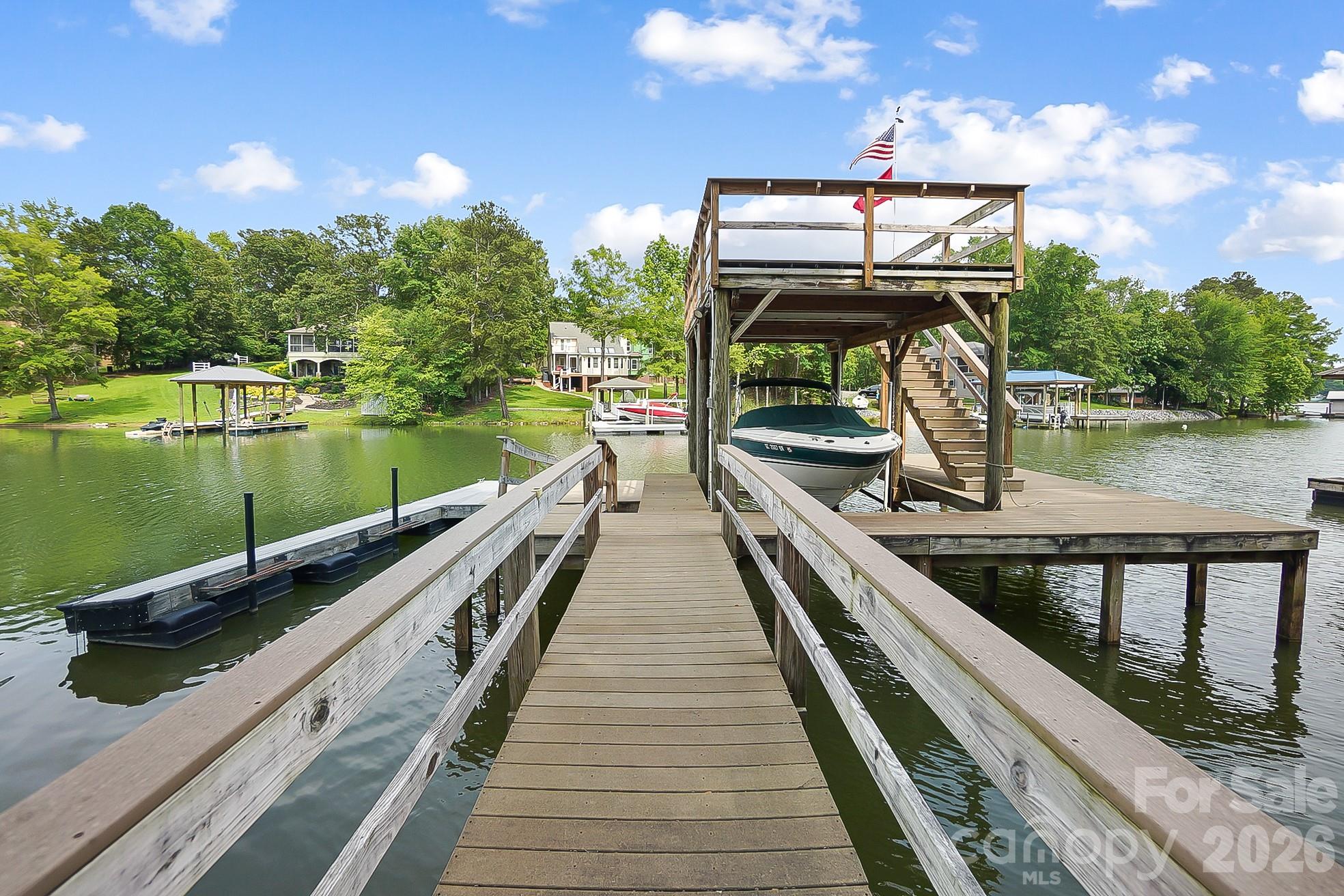 HUGE PRICE CHANGE, NOW PRICED AT ONLY $275.00 PER HEATED SQ FT INCLUDING THE LAND! SAVING YOU OVER ONE MILLION IF YOU TRIED TO DUPLICATE! 

Experience the very best of Lake Wylie living in this exceptional waterfront estate, where luxury feels comfortable, inviting, and easy to enjoy. Designed with both everyday living and entertaining in mind, the home features a spacious island kitchen with gas cooktop and double ovens, a warm keeping room, and formal living and dining areas connected by a striking see-through fireplace. The main level offers a peaceful primary suite along with two additional bedrooms, plus welcoming spaces like a sunroom, sitting room, and reading nook that give the home a relaxed, lived-in feel.

The outdoor spaces are just as inviting. A resort-style courtyard pool is surrounded by expansive decks and porches, creating the perfect backdrop for quiet afternoons or lively gatherings. The finished basement provides even more room to spread out, complete with a second living area, bar, office, two additional bedrooms, a custom craft room, and abundant storage.

One of the property’s most distinctive features is the remarkable 43ft by 43ft garage, originally built as a seaplane hangar, while offering endless possibilities today for car collectors, boating enthusiasts, or anyone in need of an extraordinary workspace. It goes far beyond a typical garage and truly sets this property apart. There is also a detached building with two garage bays, great for an office or additional entertaining space.


Life on the water is effortless with your own private boat ramp, covered dock, tanning deck, and boat lift. Whether arriving by car, boat, or imagining the days of seaplane landings, this home offers a lifestyle that is both unique and memorable. Ideal for generational living and conveniently located for an easy commute to Charlotte Douglas International Airport, uptown Charlotte, medical offices, hospitals, dining, and grocery stores. Come home, this is a place where lasting memories are made.