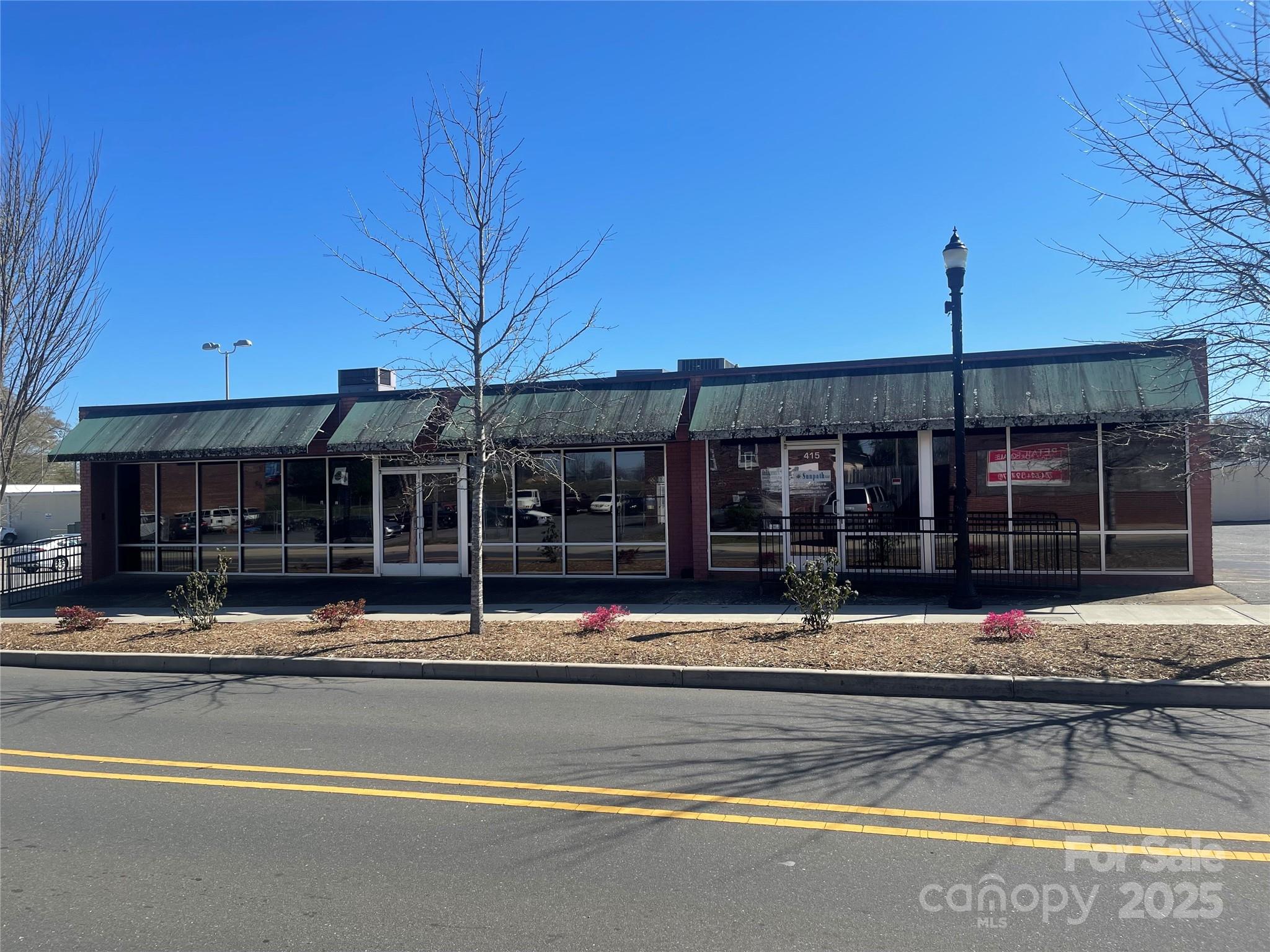 Prime Retail Opportunity in Historic Downtown Gastonia

Located in the heart of Gastonia’s thriving Central Business District, 413 W. Main Ave offers an exceptional opportunity for investors or business owners seeking prime retail space. This expansive property features over 6,000 square feet of versatile commercial space, currently divided into four retail bays, providing excellent income potential.
Situated on approximately 0.51 acres, this property enjoys high visibility and foot traffic, positioned just blocks away from the renowned Gastonia Ghost Pepper Stadium. As part of a designated social district, this location benefits from increased customer engagement and business activity.
Whether you’re looking to establish a new venture, expand an existing business, or invest in one of Gastonia’s fastest-growing areas, 413 W. Main Ave presents an unmatched commercial opportunity.