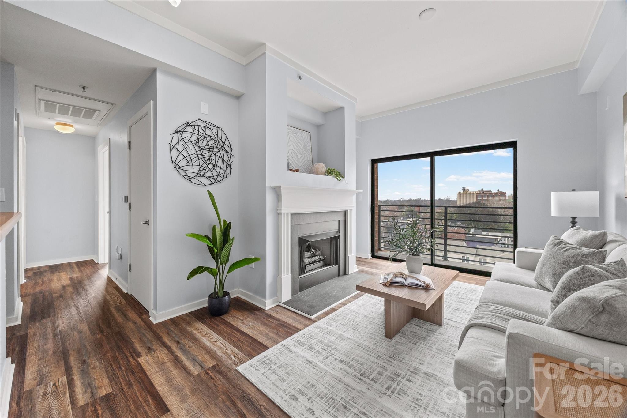 Located on the 7th floor corner of a beautiful Fourth Ward building, this two-bedroom, two-bathroom condo offers stunning year-round views of the Uptown skyline. The home features neutral paint tones, updated flooring, and plenty of natural light throughout.
The living room includes a gas fireplace and direct access to a private balcony overlooking the community pool. The kitchen is equipped with white cabinetry, stainless steel appliances—including a 2021 gas range and a 2024 dishwasher—and the refrigerator will remain. A convenient laundry closet contains a stackable washer and dryer (2022), which will remain.
The primary bedroom sits on the corner of the unit and features windows along two walls, a closet, and an ensuite bathroom with a shower. The secondary bedroom also enjoys Uptown views and is served by a hall bathroom that includes a large vanity and a tub/shower combination.
The secure building offers controlled key-fob access, a welcoming lobby, elevators, an outdoor POOL (with new pool furniture & cabanas being installed!), and a parking garage. This condo includes one assigned parking space. The unit is also just one flight of stairs or a quick elevator ride to the rooftop terrace, where residents can enjoy Uptown views or make use of the grilling station. The HOA recently installed a new roof.
Fourth Ward is known for its charming neighborhood parks, delicious restaurants, and lively seasonal festivals. The condo is located less than half a mile from the 9th Street light rail station and offers easy access to everything Uptown has to offer—including sporting events, nightlife, dining, and the arts.