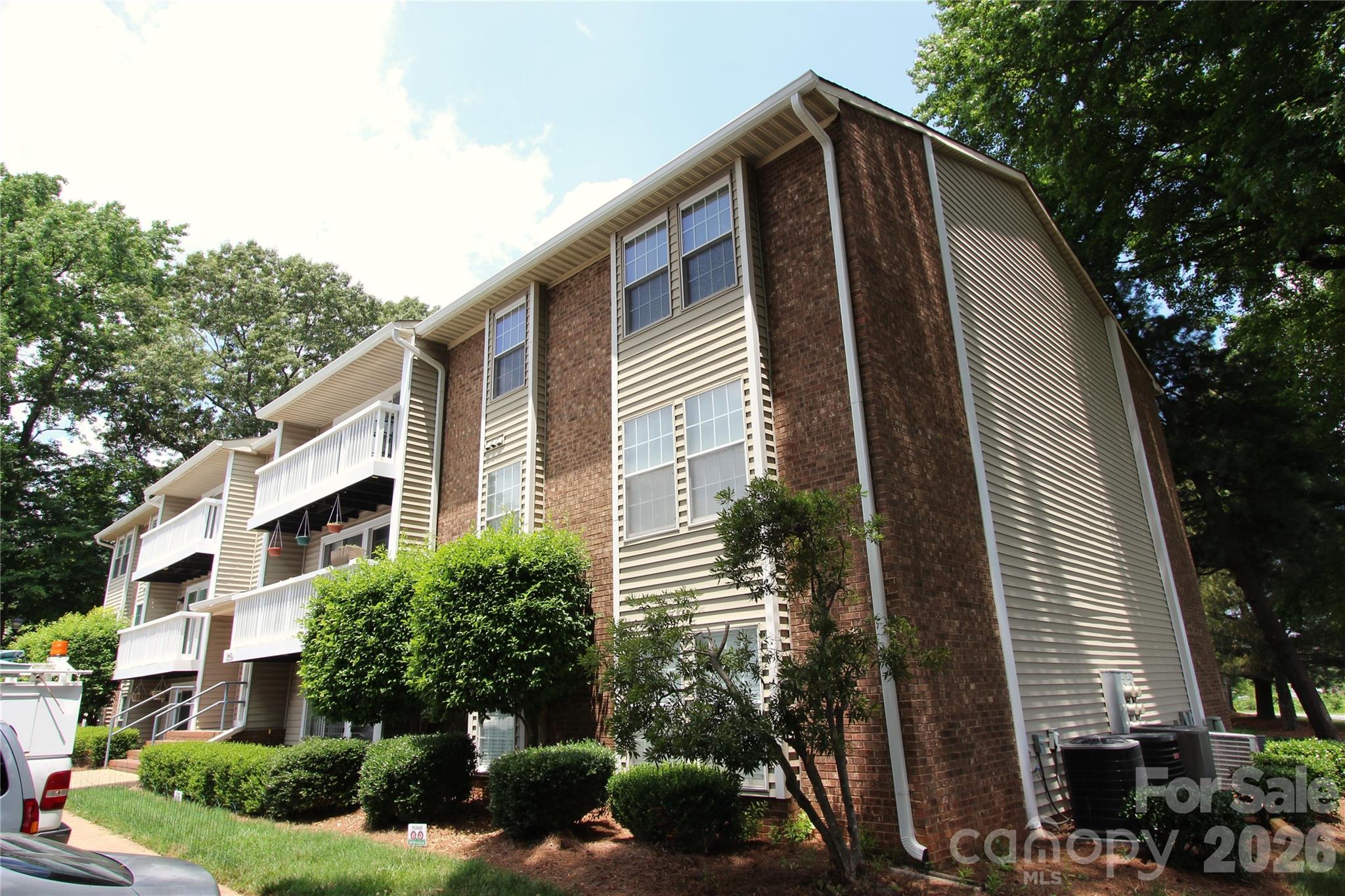 Beautifully renovated  2 BR, 2 Full Bathroom with BRAND NEW CARPETS throughout.  Open floor plan with great line of sight with connected kitchen / living room & quick access to laundry room. New oak cabinets, new modern back splash and lighting fixtures. Spacious living room is bright with sliding glass doors to covered patio. Primary bedroom has attached bathroom, ceiling fan and is approx. 14 X 11 in size.  Refrigerator included. Great location close to UNCC, less than a mile to the light rail, quick access to I-485, restaurants & shopping.  HOA dues are $199 per month. No HOA rental cap, short term rentals under 6 months are not allowed. Complex does not qualify for FHA financing. If conventional loan, we suggest buyer confirm with lender as they may or may not meet Fannie Mae/ Freddie Mac requirements. Please contact HOA for all the details. The entrance to the complex is monitored by a security camera and there is plenty of parking.
