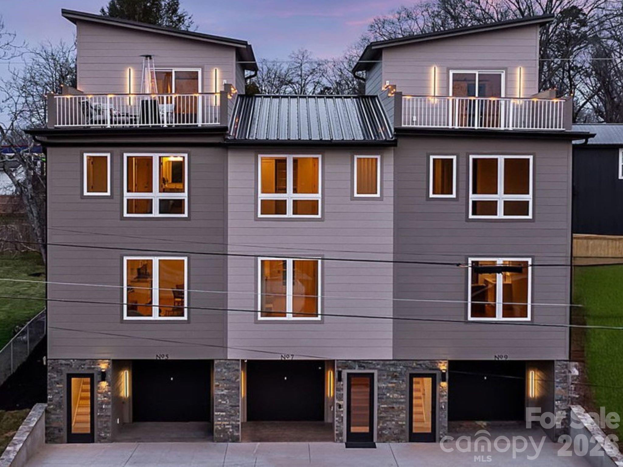Pre-Construction Opportunity! Brand-new luxury townhome to be built, where custom design, elevated finishes, and mountain views come together to create an exceptional living experience.

Planned with modern architecture and intentional detailing throughout, the home is designed to pair clean lines with refined materials. Canyon brown ledger stone at the entry and contemporary exterior lighting will create a striking first impression that continues seamlessly indoors.

Solid oak wood floors are planned throughout the home, complemented by a thoughtfully curated lighting package. The kitchen is designed to offer a streamlined aesthetic with sleek cabinetry, a luxury tile backsplash, and upscale appliances, balancing visual impact with everyday functionality.

An oversized laundry and walk-in pantry combination is designed to open directly to the patio and expansive backyard, a rare feature in townhome living that will provide a seamless indoor-outdoor connection and added flexibility for entertaining and daily living.

Each bedroom is planned as a private suite with its own en-suite bath, complemented by professionally designed closets with custom built-ins. Bathrooms are intended to feature floating vanities, tailored tile selections, and modern fixtures, creating a cohesive and elevated design throughout.

The upper-level primary suite is designed as a penthouse-style retreat, offering direct access to a rooftop terrace with mountain views. Conveniently located near downtown Asheville, the interstate, shopping, dining, and the airport, this no-HOA townhome presents a rare opportunity to secure new construction with modern luxury and thoughtful design. A completed version of this floor plan is currently available and can be toured to showcase the quality of construction, design, and finishes anticipated for this home.