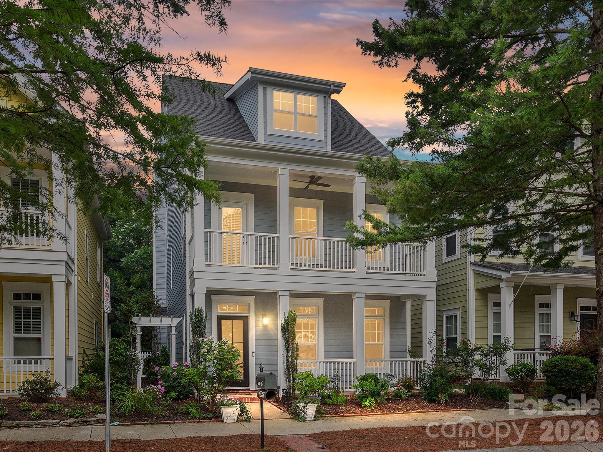 Charming Wesley Heights home with an unbeatable proximity to Uptown! Featuring a classic Charleston-style two-story front porch, this home offers endless updates throughout, hardwood floors, arched entry ways, and an open living and kitchen area. The kitchen boasts modern white cabinetry, quartz countertops, tile backsplash, stainless steel appliances (2024), a large island with at-counter seating, and a spacious pantry. Living room with a stone fireplace & formal dining room or office with picture frame molding and slider doors. Generous primary suite with a walk-in closet, private porch access and a thoughtfully redesigned bathroom with a dual sink vanity, soaking tub, and a frameless tiled shower. Two additional bedrooms, each with walk-in closets, share a hall bathroom. Enjoy incredible outdoor living with a paver patio and outdoor kitchen with a built-in grill. Amazing location close to the Stewart Creek greenway, Frazier Park, Uptown, the new Savona Mills development and Wesley Heights shops and restaurants. New roof 2026, fresh exterior paint 2026, 2 car rear garage with new smart garage opener & springs 2026. Water heater 2023. Solid wood & rain glass front door & ceiling fans 2025.