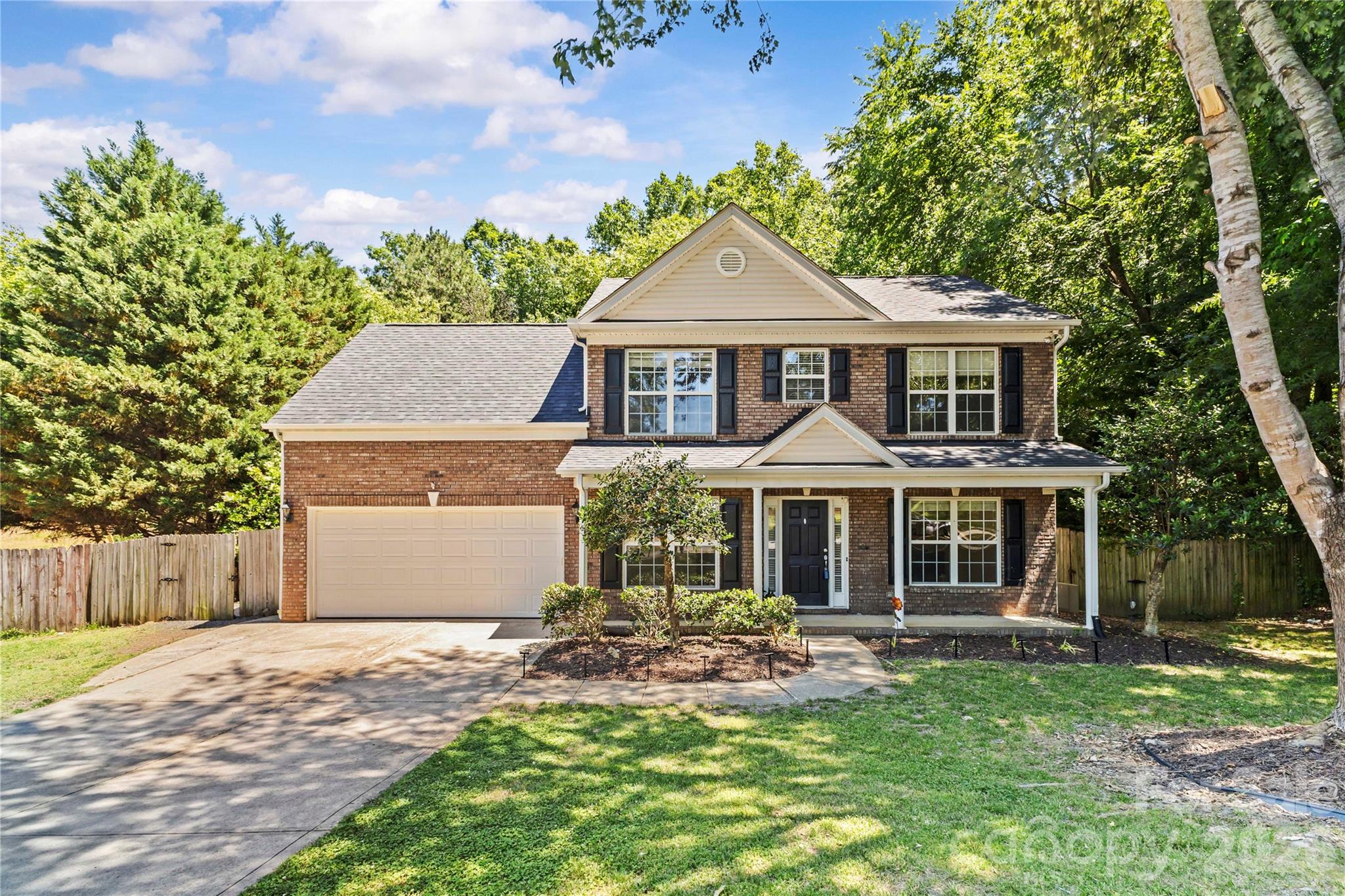 Welcome to 8119 Poplar Grove Cir in the heart of Waxhaw — a beautifully maintained 4-bedroom, 2.5-bath home ideally located just about one mile from charming downtown Waxhaw, where you’ll enjoy local dining, shopping, coffee shops, breweries, and year-round community events. Situated in a quiet, established neighborhood with optional HOA, this home offers the perfect combination of comfort, convenience, and flexibility.

From the moment you arrive, the inviting covered front porch creates a warm first impression and the perfect place to relax and unwind. Inside, you’ll find a spacious and functional layout with thoughtfully designed living spaces ideal for both everyday living and entertaining. The bright living room features surround sound and flows seamlessly into the kitchen and dining areas, creating an open and welcoming atmosphere.

The kitchen offers ample cabinetry and counter space. Laundry room and a half bath also conveniently located on the first floor. Upstairs, the spacious bedrooms provide flexibility for family, guests, home office space, or hobbies. The primary suite offers a comfortable retreat with a walk-in closet and ensuite bath featuring a relaxing garden tub.

This home has been professionally freshly painted and features a brand-new roof, brand new carpet upstairs, giving buyers peace of mind and a move-in ready experience.
Home also come included a central vacuum system, propane tanks, security system, irrigation system, updated lighting and fans, and a whole-house Generac generator already installed — a rare and valuable addition.

Step outside to enjoy the large backyard designed for entertaining and outdoor living. The beautifully maintained yard offers plenty of room for gatherings, pets, gardening, or simply relaxing in your own private outdoor space. The screened porch with Eze-Breeze windows and propane fireplace creates the perfect year-round extension of the home.

Located in a highly desirable area with great schools, this home offers the charm of small-town living while still being conveniently close to everything Waxhaw and the greater Charlotte area have to offer. A rare opportunity to own a this pretty home in one of Union County’s most sought-after communities.