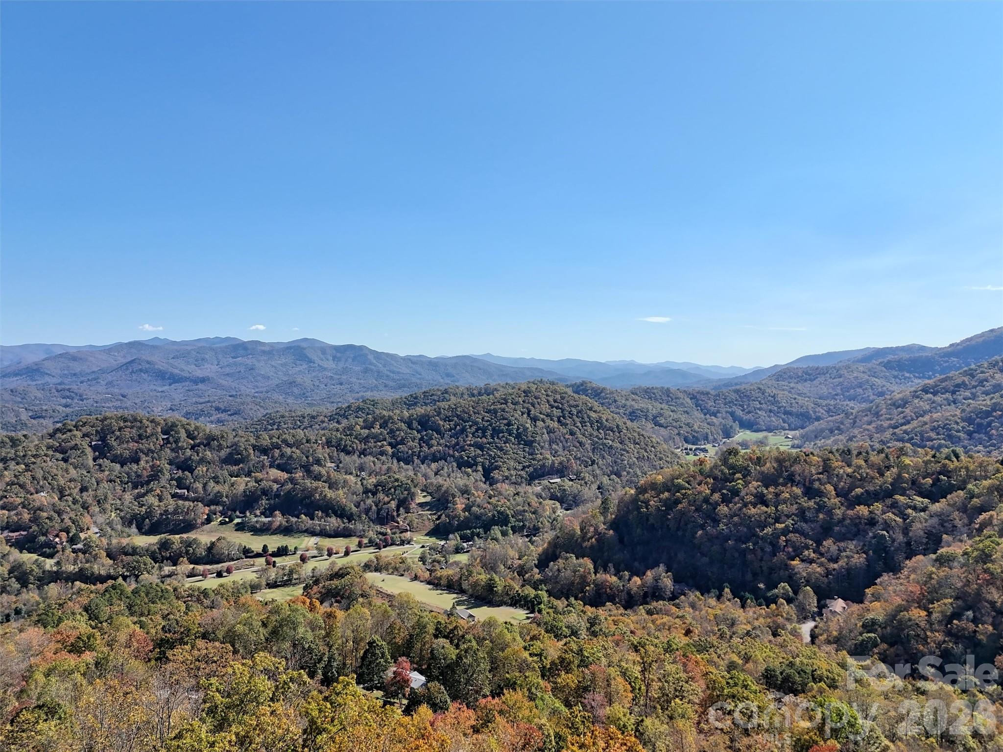 LEVEL AREA WITH STUNNING VIEWS. What an incredible opportunity to build in the UNRESTRICTED community of Indian Trail off of Conley Creek Rd. Primary or second home, great for a vacation rental, or use for off grid living. This lot offers a roughed in driveway, cleared area for building (minus a few trees), magnificent year round views with minimum clearing, and a gravity-fed spring already connected to the lot. There is a 1200 gallon reservoir tank on this lot that is shared with lot 7. Indian Trail has electric throughout, paved roads in most of community, never ending views of the surrounding mountains, and a blend of successful short-term rentals and part-time and full-time residents. 
Come envision your mountain home looking out at the expansive peaks of Soco gap, Richland Balsam, Cherokee, Waterrock Knob, and Cullowhee. Combine this with lot 7 next door for added privacy, Lot 7 even has a negotiable, off-grid structure for temporary shelter while building or vacationing.
***Drone Long range mountain view photos were taken 7 ft above the level area for accurate possible views from a home*** Panoramic video from williamson road (above lots) in links.

Seller is also offering this as a leased lot. Call agent if interested.