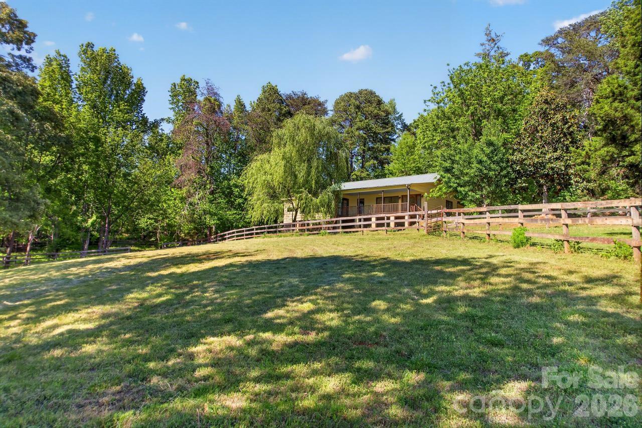 WINTERBROOK FARM is a gorgeous, private equestrian property in the heart of horse country, offering direct access to the CETA trail system. Conveniently situated between Landrum, SC, and Columbus, NC, this farm is moments from TIEC, FENCE and Tryon Equine Hospital. The charming home, exterior freshly painted, features reclaimed heart pine and cherry flooring, two bedrooms, two baths, an office, living room/dining area, wood floors and a large covered porch, perfect for enjoying peaceful farm views and sunsets. The property offers multiple ideal building sites should you wish to construct your dream home. The farm's 9.02 acres include rolling pastures with established grass and fencing, and a creek, all providing an excellent setting for horses. This is a rare opportunity to own a well-located horse property combining privacy, functionality and proximity to world-class equestrian facilities.