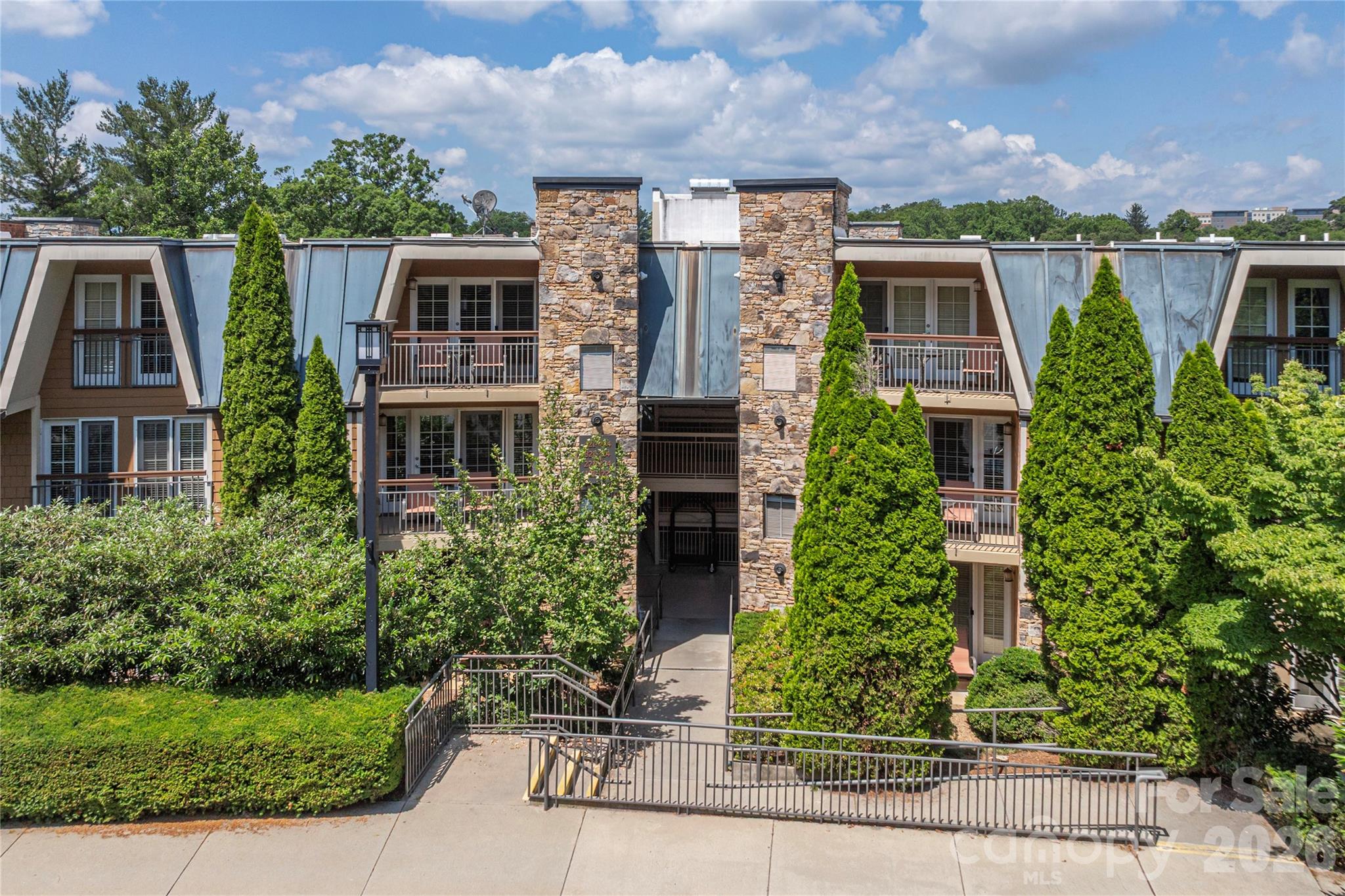 This turn key short-term rental in Downtown Asheville across from Mission Hospital isperfect for weekend getaway or passive income. Wonderful opportunity to own an upscale condo in Biltmore Village. Features include granite counter tops, open floor plan, gas fireplace, stainless steel appliances, hardwood floors & walk-out terrace. One very large bedroom with king bed and huge tile bathroom has soaking tub and separate shower with glass surround. Community amenities include heated pool/hot tub, fire pit, 24/7 concierge, fitness center & abundant parking. This unique complex is managed by on-site property management firm.  Easy access from the same level parking area no steps and easy ramp for access. Pool and recreation area is just across the parking lot. Booked almost all of June. Please call for more details.
