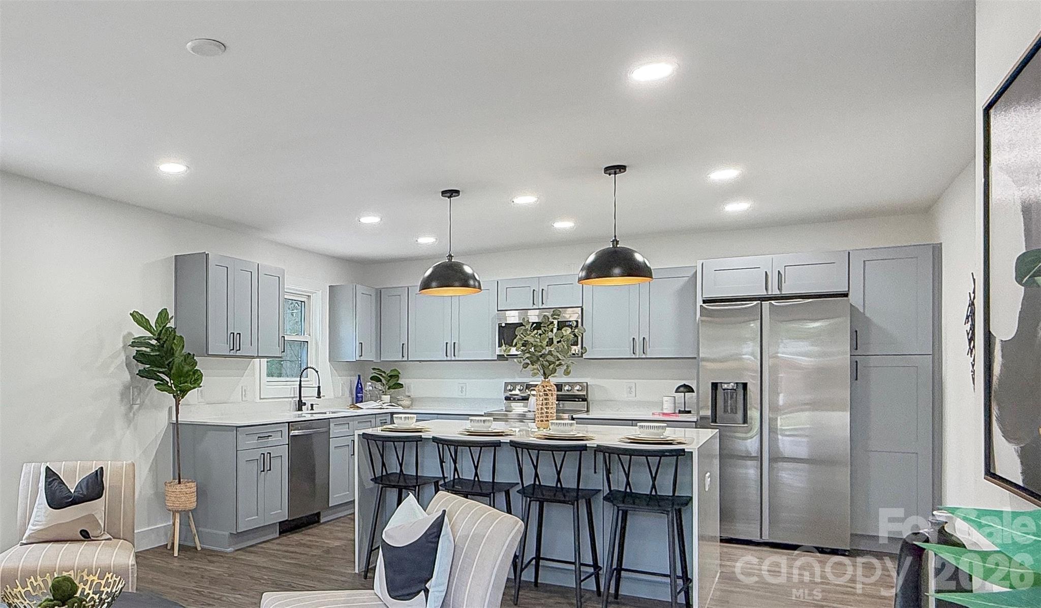 Beautifully renovated home showcasing exceptional workmanship and thoughtful design throughout. This move-in-ready property features a brand-new HVAC system, stylish LVP flooring, and a completely updated kitchen with new cabinetry, quartz countertops, and a stunning waterfall-edge island, perfect for both everyday living and entertaining.

Every detail has been carefully considered, including all new light fixtures and plumbing fixtures, creating a fresh, modern feel from top to bottom. The spacious layout includes a large laundry/mud room, offering both functionality and convenience.
Step outside to enjoy a flat, fully fenced backyard—ideal for gatherings, pets, or simply relaxing in your own private outdoor space.
Conveniently located, this home offers easy access to NoDa, Uptown, and Plaza Midwood, putting dining, entertainment, and major highways just minutes away. 
Enjoy the perfect balance of a quiet residential setting with close proximity to vibrant city living. This is a must-see opportunity you don’t want to miss.