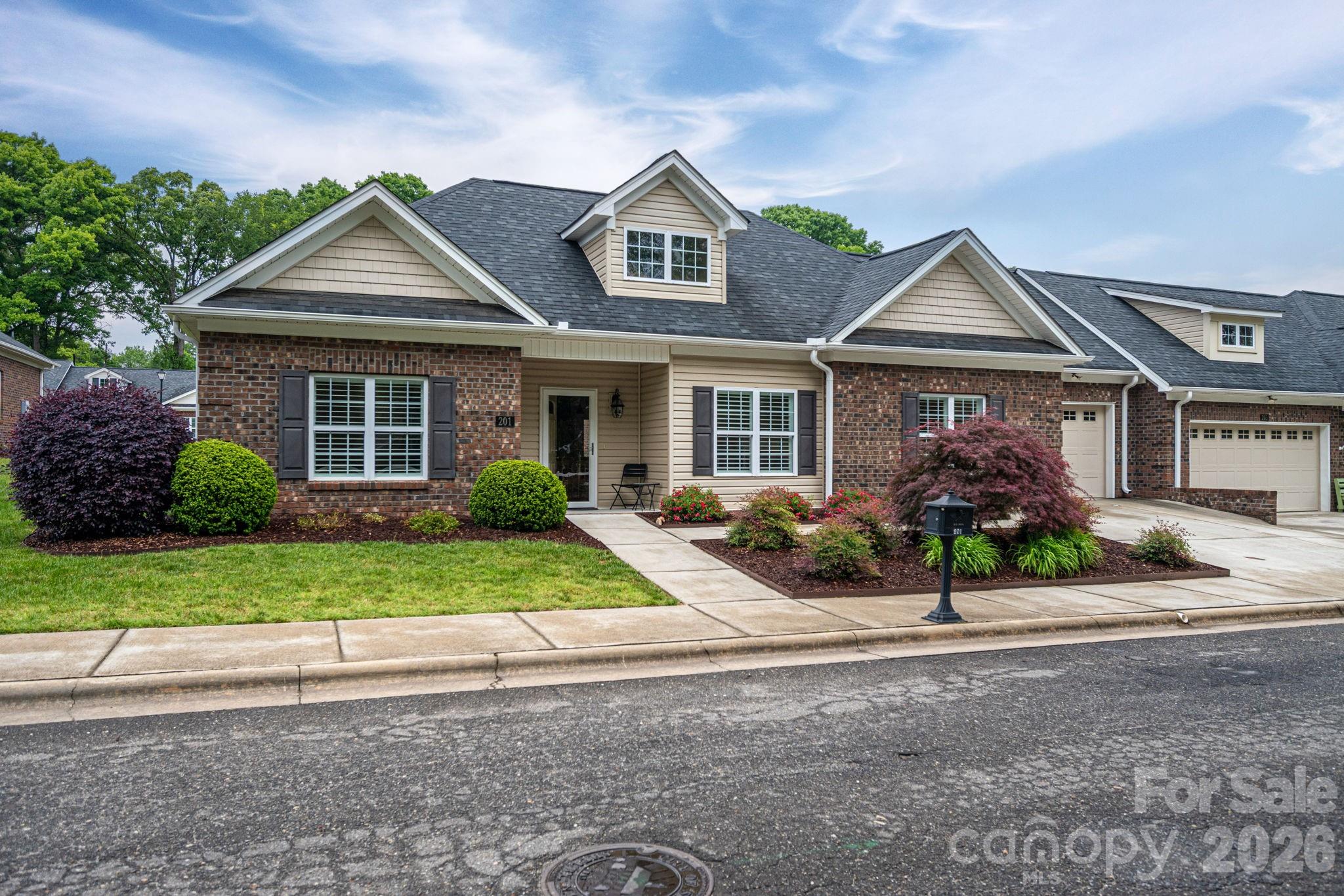 This charming 2019-built townhouse offers the low-maintenance lifestyle you’ve been looking for. Situated in a premier 55+ community, this home perfectly balances quiet residential living with prime accessibility: Located just minutes from downtown shops, dining, and essential medical services, ensuring everything you need is within easy reach. You’ll be greeted by attractive, professional landscaping that provides immediate curb appeal without the work—lawn maintenance is fully included in the community services. Rare 3-Bedroom Layout: Unlike the standard two-bedroom units typically found in senior living, this home features three generous bedrooms, providing ample space for a home office, hobby room, or overnight guests. The heart of this home is a large, open-concept kitchen boasting modern finishes, expansive counter space, and plentiful storage—perfect for hosting family gatherings or prepping a quiet meal at home. The community is steps away from the Neal Senior Center, easily accessible via well-maintained neighborhood sidewalks.