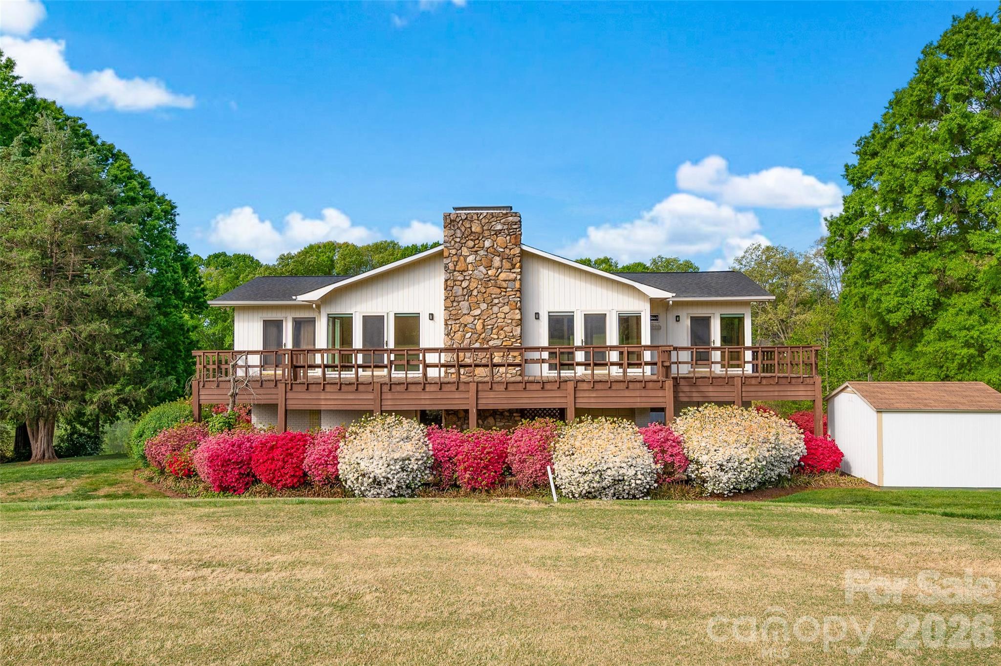 Contemporary-style home offering a unique blend of character, natural light, and scenic golf course from the back deck and pond views from the front deck. The open living spaces are highlighted by warm wood ceilings and expansive windows that bring in abundant natural light and showcase the surrounding landscape. The kitchen and living areas provide a functional layout for everyday living and entertaining. The spacious layout flows seamlessly to a large wraparound deck, ideal for enjoying those views! On this level, is also the primary with an updated en-suite bath and an additional updated bath on this level provides comfort and flexibility. The lower level offers extra space that is perfect for privacy including a recreation room,  two bedroom, full bath w/ shower-tub combo and 2 car garage with room for golf cart, workshop potential, or ample storage. The well landscaped exterior with mature plantings enhances the setting-- a rare opportunity combining modern design elements with a tranquil, view-filled environment. Truly one of a kind.