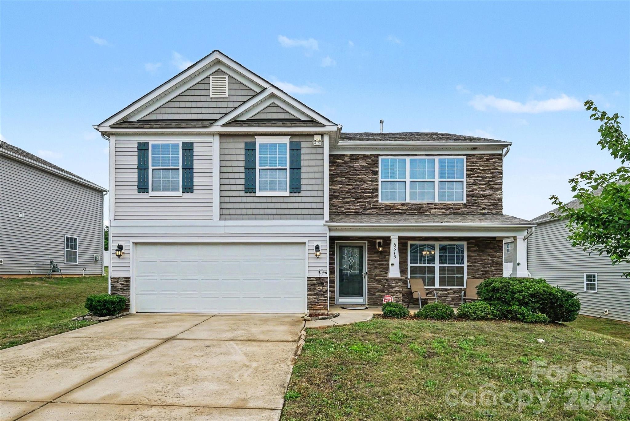 WATCH 3D TOUR! Spacious home in the desirable Lanier Village community offering flexible living space, a large backyard, and convenient access to Charlotte, Concord, and I-485! Built in 2018, this well-maintained home features an open floorplan with hardwood flooring throughout the main open living areas. The formal dining room is surrounded by crown molding and the bright living room centers around a cozy gas fireplace. The kitchen is equipped with granite countertops, subway tile backsplash, stainless steel appliances, oversized cabinetry with molding, pantry, and ample prep space for everyday living and entertaining. A rare main-level bedroom with full bath creates the perfect setup for guests, multi-generational living, or a private office. Upstairs, the oversized primary suite offers a spacious walk-in closet, dual sinks and spacious shower, along with three additional bedrooms and upper-level laundry. Enjoy outdoor living in the large backyard with patio space and room to play, garden, or entertain. Additional highlights include spacious secondary closets, attached 2-car garage, updated ceiling fans in two upstairs bedrooms, fresh dining room paint, and recent HVAC repairs completed in 2026. Community amenities include a pool, cabana, and playground, all conveniently located minutes from Concord Mills, shopping, restaurants, grocery stores, and major commuter routes.