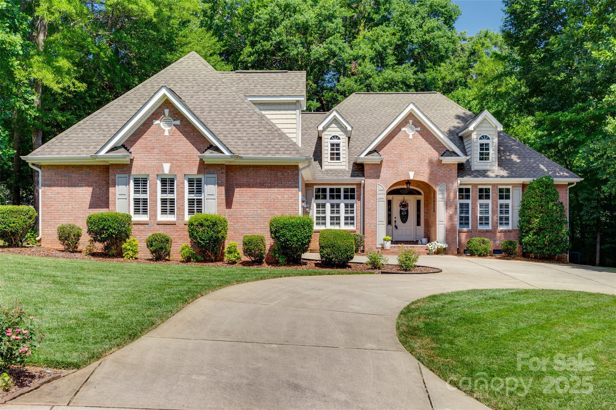 Absolutely beautiful all-brick home on a .59 acre lot in Lake Wylie!! You will fall in love with the privacy of this home with lush landscaping, no home on either side and large shade trees. The u-shaped driveway leads to an oversized 2-car garage and a welcoming covered porch. The main floor features hardwood flooring, large windows w/ plantation shutters, a great room w/ a vaulted ceiling, built-in shelving and an electric fireplace, a formal dining room, a sunny breakfast nook, and a spacious kitchen w/ a gas range and granite counters. There are also 3 bedrooms on the main level including the primary suite w/ a tray ceiling and separate closets and two secondary bedrooms w/ spacious closets and a jack-n-jill bath. Upstairs you will find an oversized bonus room with a full bathroom and ample walk-in attic storage. The covered rear porch overlooks the private, level backyard. Water heater and main floor HVAC are from 2024. Clover Schools and Low Taxes! Don't let this one get away!
