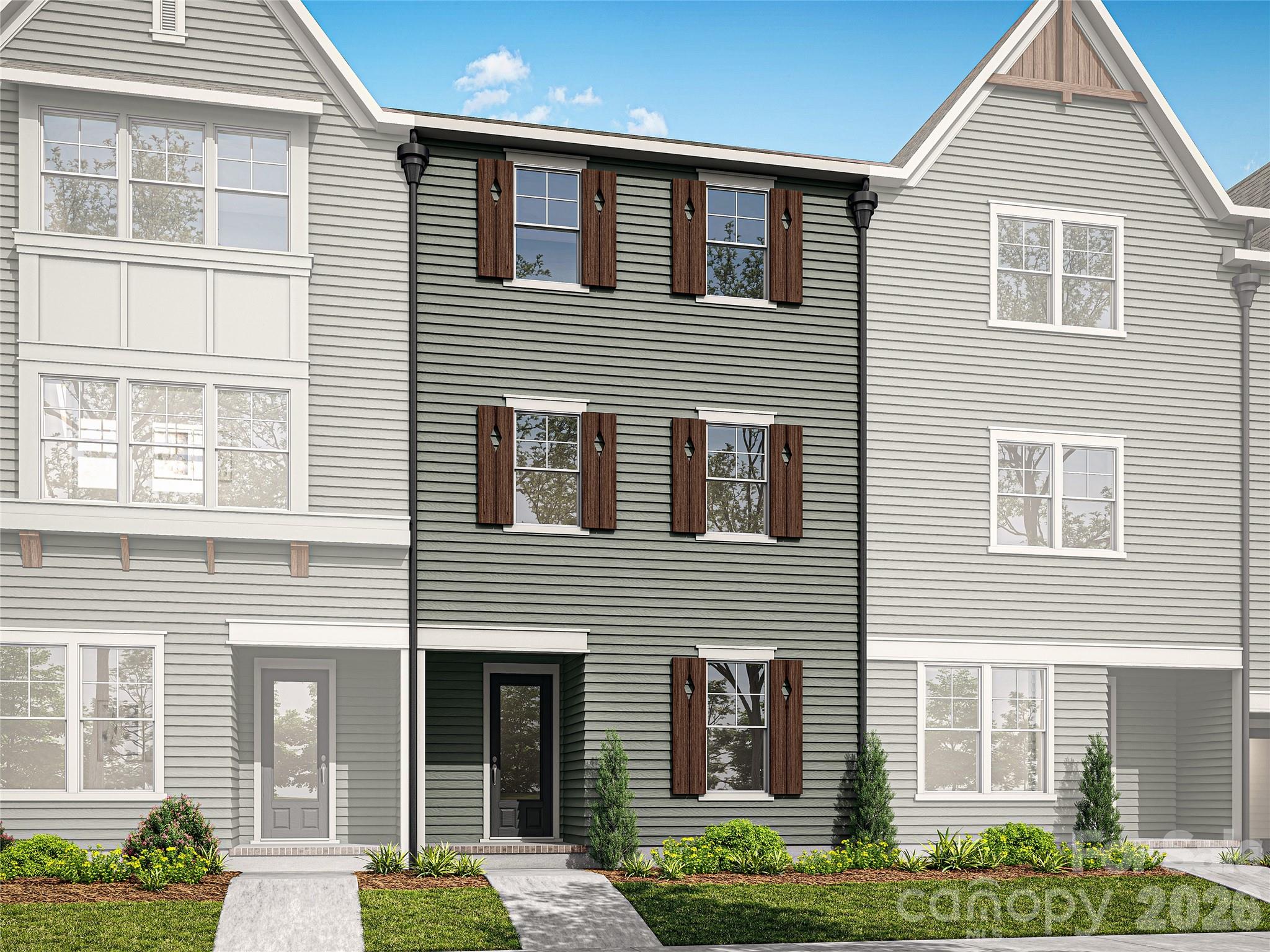 NEW CONSTRUCTION in East Charlotte - This townhome is one of six in this gorgeous building. The lower level offers one guest suite with a private bath - walk in shower with ceramic tile walls and floor. The common area is located on the main level and provides an open concept design with family room, dining area and kitchen with quartz counter tops, under cabinet lighting and center island with single bowl stainless kitchen sink. Electric fireplace in the family room with vertical shiplap backing. Luxury vinyl plank flooring in all common areas plus upper hallway & primary bedroom.  Carpet in guest bedrooms. 2X2 wood picket stair railing with oak step treads on both staircases. Primary bedroom suite located on the third level. Bath includes a double sink quartz vanity, oversized tiled shower and huge walk-in closet.  Third level guest suite has full bath with tub/shower combo and ceramic tile walls/flooring. Laundry room with cabinets located on the third level conveniently positioned near the primary bedroom and guest suite. Generously sized covered rear porch on the main level for ultimate privacy and relaxation on warm evenings. Two-car attached drive-under garage with opener and 2 remotes included- located on the lower level.