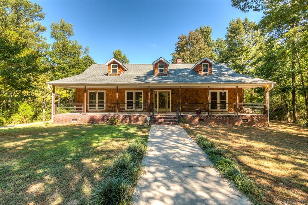 VERY RARE- Tucked away Brick/Cedar Ranch on ~4 Acres in SC & 10 mins to Ballantyne & 485 w/an extra Det. 550+ sf 2 Room Apt/Ofc w/ full bath & kitchenette area. Home partially remodeled in 2009.  Real hardwoods in most of home, updated kitchen & storage plus.  Vaulted GR & open living area, split BR plan & extra BR/Bonus +1/2 bath up. HUGE Det. garage/workshop. Homes can be modified but property like this doesn't come along often. All info deemed accurate but should be verified by buyer.