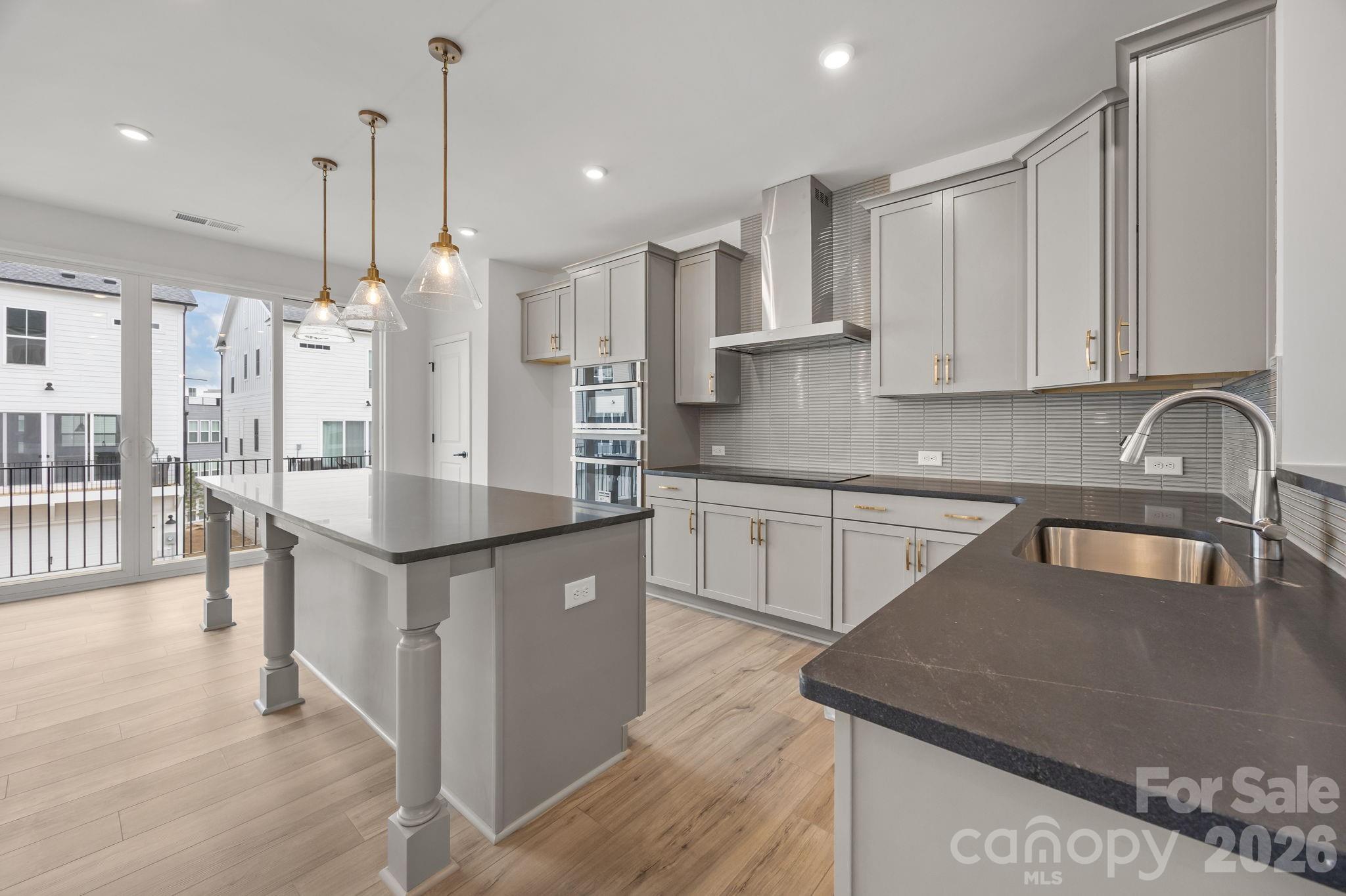 Welcome to The River District—a true master-planned community where lifestyle and location come together beautifully.

This beautifully appointed Landon three-story townhome offers a thoughtfully designed layout with a first-floor guest bedroom and full bath—perfect for visitors, multigenerational living, or a private home office.

The second level showcases a gourmet kitchen featuring quartz countertops, a built-in oven and microwave, electric cooktop, and soft-close cabinetry. The open-concept dining and living areas create an inviting space ideal for entertaining, while sliding glass doors lead to your private balcony—perfect for relaxing or enjoying your morning coffee.

Upstairs, you’ll find two beautiful owner’s retreats, each offering a bright, airy bedroom and a spa-inspired bath for ultimate comfort and privacy. A conveniently located laundry area completes the upper level.

This home is filled with beautifully curated interior finishes, individually hand-selected by our professional design team, creating a cohesive and elevated aesthetic throughout.

Location is everything—and at The River District, you’re truly minutes from it all. Planned community amenities include a resort-style pool, clubhouse with fitness center, tennis and pickleball courts, parks, scenic trails, a working two-acre farm with an on-site farmer, and a riverfront amphitheater.

Day on Market Reflect construction time.
