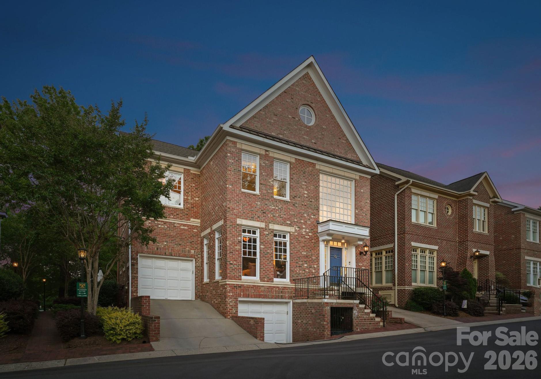 Situated in the heart of Dilworth, this end-unit townhouse offers an exceptional opportunity within one of the neighborhood's most coveted and walkable enclaves. Originally reimagined by designer Scott Carpenter, the home spans four levels with soaring ceilings, an open iron staircase, and an incredible backyard patio. 

A grand two-story foyer welcomes you inside, leading to the fully updated, showstopping speakeasy lounge, complete with custom display shelving, stylish wallpaper, and elegant lighting. The chef's kitchen features a stainless steel appliance suite, stone countertops, and barstool seating. A dramatic three-story dining area and a living room anchored by a gas fireplace, wet bar, and built-in cabinetry complete the main level, with seamless access to the backyard.

Upstairs, the primary suite offers custom wood-paneled walls, a private balcony, and a spa-inspired bath with sauna shower, and a custom built-in open closet area. Two additional ensuite guest bedrooms provide well-appointed accommodations, each with ensuite bathrooms, custom closet systems, and high-end finishes throughout. 

The lower level features a fourth bedroom, a full bath, and a private home theater with a 70" television and theater chairs. Additional areas include a dedicated fitness room, two garages, and a spacious attic on the fourth level.

The outdoor living experience is truly exceptional. A fully fenced and gated stone patio with professional hardscaping and landscaping creates a private sanctuary designed for year-round enjoyment. The built-in Lynx grill station is ideal for alfresco dining, while a serene pond with an integrated water fountain adds a tranquil ambiance. Gather around the gas fire feature lounge area on cool evenings, or stay cool in the warmer months with the dedicated cooling and misting fan.

Ideally positioned just minutes from Uptown Charlotte, South End, and Midtown, this home offers effortless access to the city's top dining, boutique retail, and major roadways. Families will appreciate proximity to some of the area's most sought-after public and private schools, making this a rare offering that delivers on both lifestyle and location.