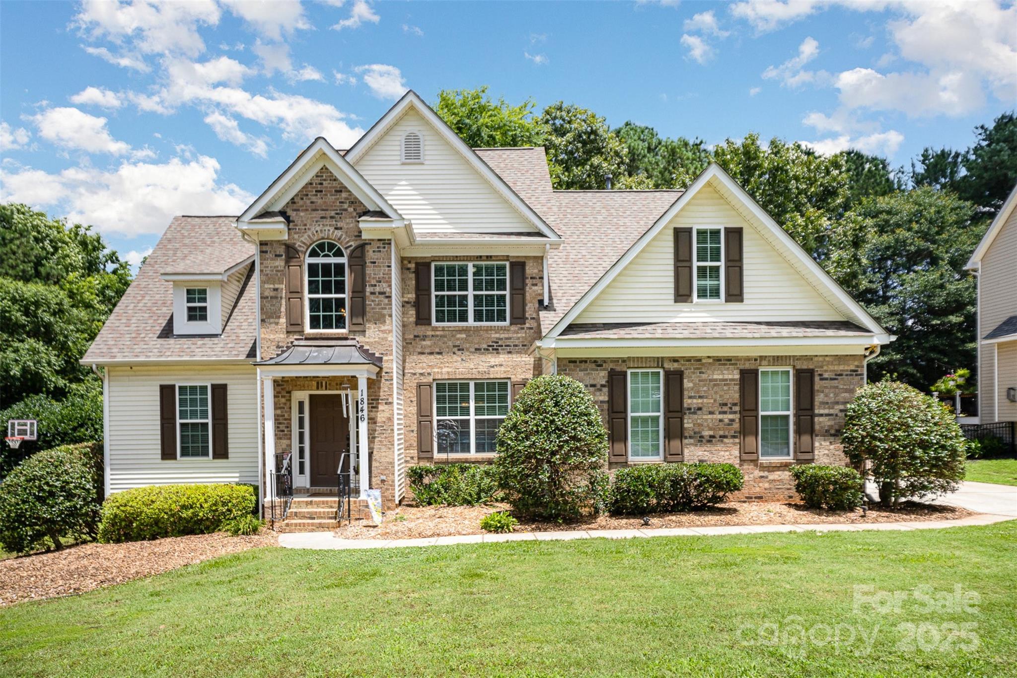 Welcome to this inviting Sutton Place home, tucked away on a cul-de-sac in the top-rated Fort Mill School District. Step into a bright two-story foyer that opens to a formal dining room and a spacious great room with soaring ceilings and a cozy gas fireplace. The kitchen features granite counters, stainless appliances (newer stove and dishwasher), and all major appliances—including the fridge, washer, and dryer—stay.
The main-level primary suite offers a peaceful retreat, while upstairs you’ll find three additional bedrooms and a full bath with dual vanities. Enjoy the outdoors on your large deck with a gas line ready for grilling!  Deck overlooks a fenced backyard with a wooded buffer. Other highlights include updated tile in the laundry and upstairs bath, newer main-level HVAC, and a welcoming copper-roofed front porch. Perfect location -  close to Baxter Village, I-77, Catawba Park, and Lake Wylie boat ramps.