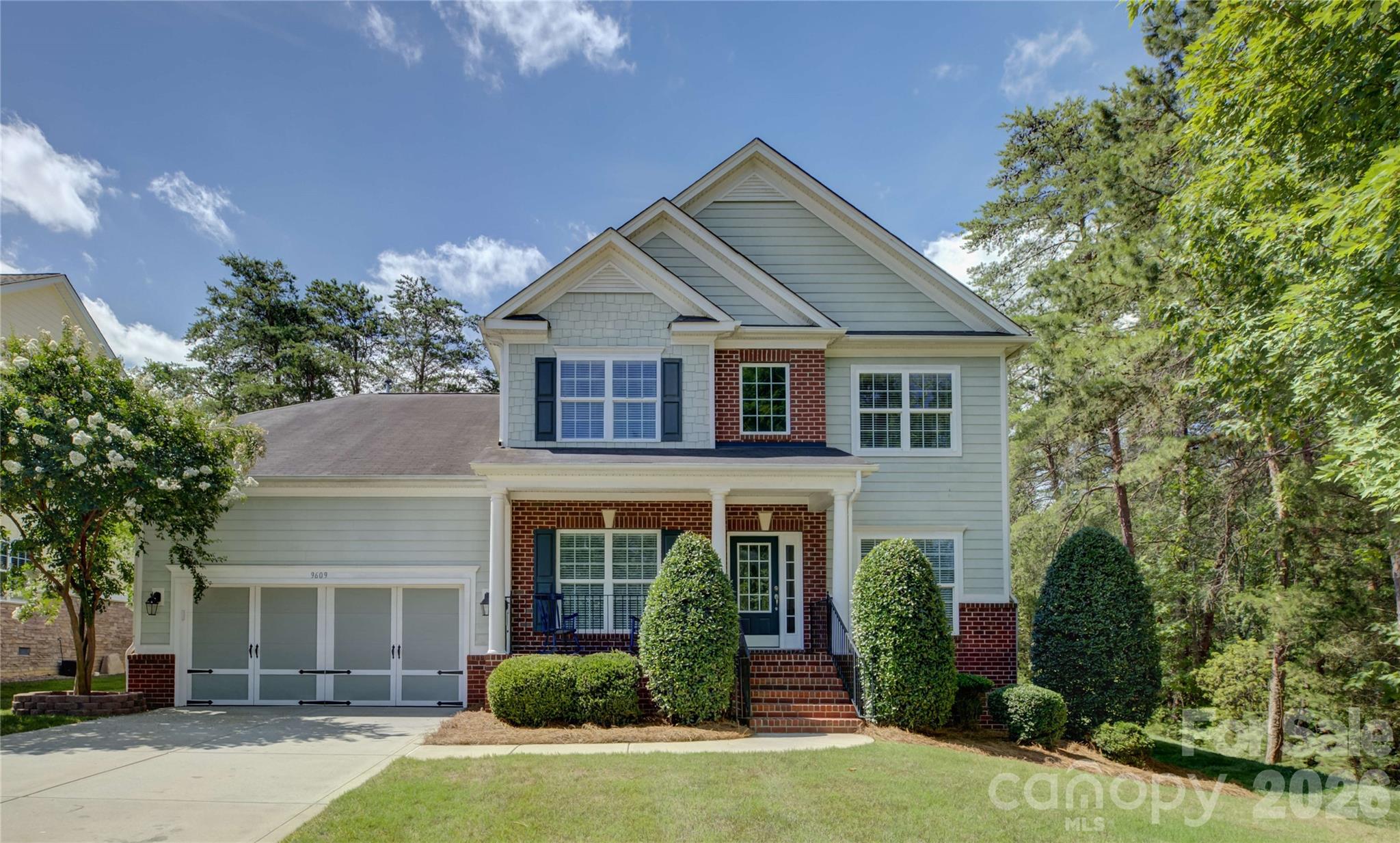 Located in the amenity-rich Palisades community, this beautifully appointed home welcomes you with a charming rocking-chair front porch and a grand two-story foyer. Elegant formal living/office and dining rooms flank the entry, with the dining room showcasing a tray ceiling, wainscoting, and arched entryways adding timeless architectural detail. The well-appointed kitchen features an electric range, granite countertops, breakfast bar seating, and abundant cabinetry, and flows seamlessly into the breakfast room, with access to an expansive deck overlooking a private backyard retreat complete with a paver patio, fire pit, in-ground irrigation, and a tranquil water feature. The light-filled great room impresses with soaring two-story windows and a cozy gas fireplace, creating the perfect space for gathering. The main-level primary suite offers a peaceful retreat with a tray ceiling, dual vanities, soaking tub, and glass-enclosed shower. Upstairs, a versatile loft provides additional living space, while two spacious bedrooms and a full bath complete the upper level. Residents of The Palisades enjoy exceptional amenities, including the clubhouse, Olympic-size pool, pickleball and game courts, fitness center, and miles of scenic walking trails, all within a vibrant country club lifestyle community. Full landscaping service is included in the HOA fee