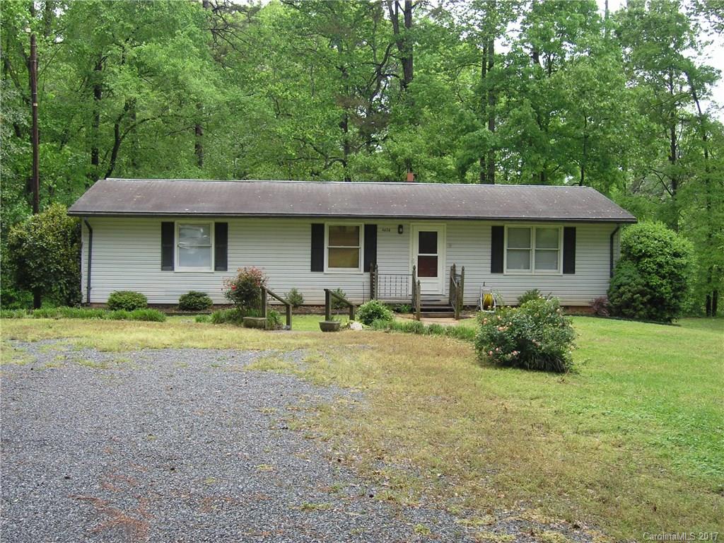Great basement home with over 2500 total sq. ft. Walk out basement could easily be heated but does currently have a woodstove. Ton's of possibilities. New laminate flooring installed throughout main level. 30x22 detached wired shop with a 15x29 carport on the side and a 14x23 concrete pad in front. Plenty of room to work on vehicles. 12x23 rear deck with built in seating and a 12x35 patio with a fire pit area. Very private country living but min's from Charlotte, Mt. Island, Huntersville.