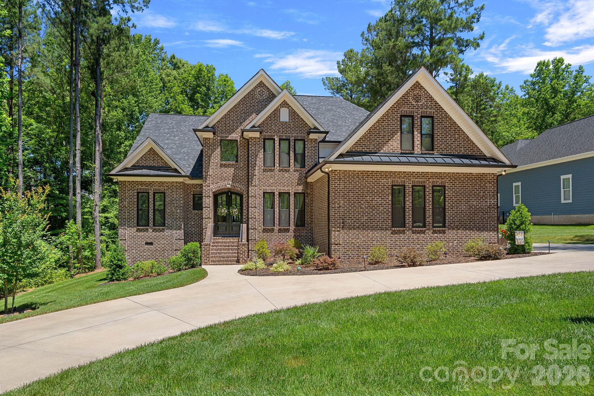 Some homes check the boxes. This one rewrites the list.
Welcome to 156 Crooked Branch Way, where every detail has been thoughtfully designed and every space feels like a retreat. From the moment you arrive, the professionally landscaped yard, landscape lighting, and three-car garage set the tone for what's waiting inside.
At the heart of the home is a stunning main-level primary suite that feels like a private getaway, complete with a spa-worthy bathroom designed for relaxation. The beautifully appointed kitchen is equally impressive, featuring premium ZLINE appliances and spaces that effortlessly blend everyday living with entertaining.
Upstairs, the home truly shines. Four additional bedrooms surround a spacious central bonus room complete with its own wet bar—perfect for movie nights, game days, a kids' hangout, or a second living area that everyone can enjoy. And with a second laundry room upstairs in addition to the main-level laundry, convenience is built into every corner of this home.
Step outside and you'll find another favorite gathering spot: a covered patio with a fireplace that's made for everything from quiet mornings with coffee to evenings spent with family and friends. The sellers have thoughtfully added upgrades that make this home even more exceptional, including professional landscaping, landscape lighting, a complete irrigation system, backyard fencing, a water softener, and a reverse osmosis system for pure drinking water.
With views of Lake Norman and access to a community pool, this home offers not only incredible spaces but an equally amazing lifestyle.
Every room, every upgrade, and every thoughtful detail at 156 Crooked Branch Way was designed to impress. This isn't just a house—it's the home that has everything.