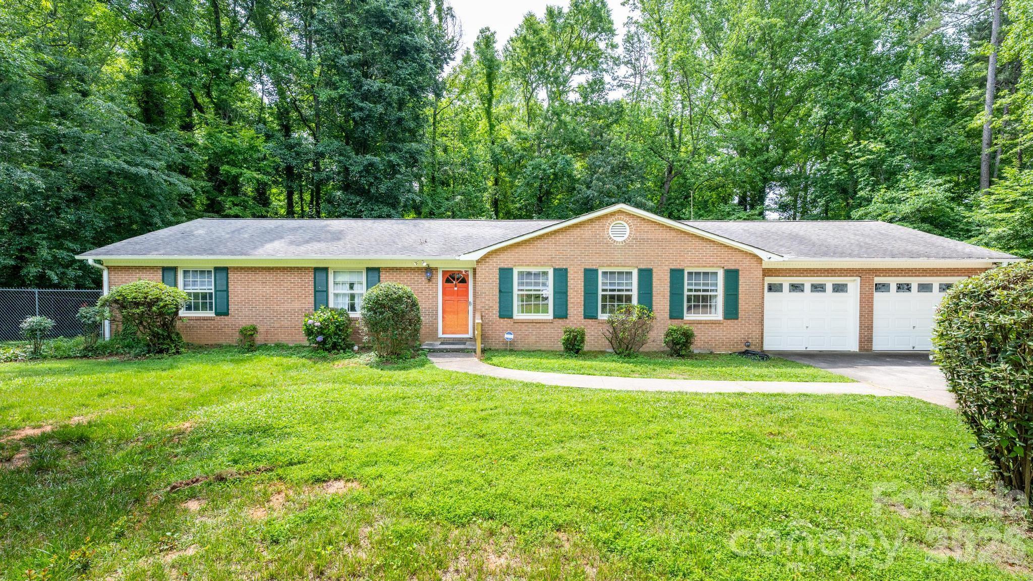 Spacious brick ranch home on nearly 3/4 acre lot with beautiful shade trees, fenced back yard, 3 generously sized bedrooms and 2 full baths, oversized garage.  Must see this location on one of the lovely, tucked-away side streets near South Elementary.  This is truly a fabulous location and you won't be disappointed.  Home is priced to allow for updates needed, and included are some staged photos to show how easily this home could be transformed!  Renovate this lovely home and have a true gem on a hard-to-find large lot -- with highly desired Mooresville schools and a thriving downtown, offering fine dining and shops, just blocks away.  Seller recently made improvements to the crawl space, replaced the sewer line in the front leading to the street, and added the fencing in the rear yard, but most of the interior is original.  Home was built by the current owner and her husband.  This is the kind of neighborhood you don't move out of because they are hard to find! **Rear property line is well behind the fence -- approx. 70' on the right side and 90' on the left side, so rear fence line could be extended much further back for a larger yard.  Plenty of room for a pool and/or detached garage here too!***