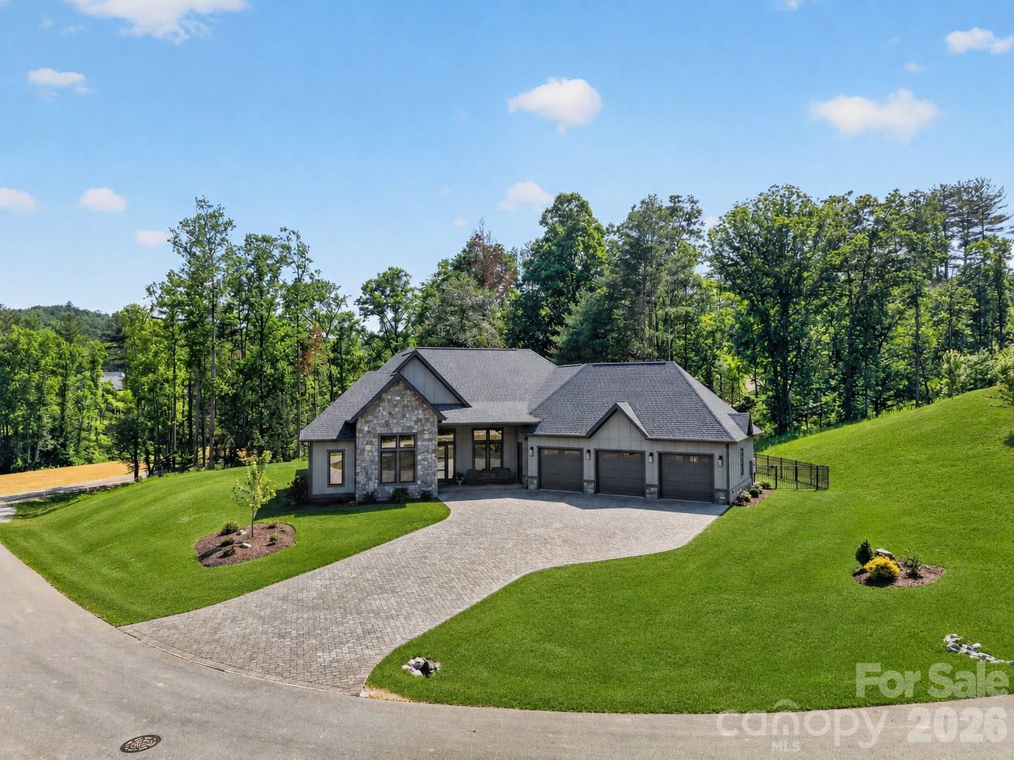 Experience refined mountain living at 422 Ascension Valley, a meticulously maintained 3BR/2.5BA home situated on a premier 2.70-acre lot—one of the largest, most buffered parcels in Horse Shoe Cove. A beautiful paver driveway and thoughtful landscaping establish striking curb appeal from the moment you arrive. While this highly desirable community continues its new construction phase, this exceptional property offers a rare opportunity to avoid building timelines and move into a fully finished, meticulously maintained home complete with owner upgrades like maintenance-free fencing and a whole-house generator that new construction rarely includes. Inside, soaring 12-foot ceilings and large, European-style tinted windows flood the home with natural light while maintaining energy efficiency and privacy. The gourmet kitchen is designed for high-end functionality, fully equipped with premium Thermador appliances, custom cabinetry, and generous prep space perfect for both everyday living and hosting. The thoughtful layout flows seamlessly through the main living areas, featuring upscale finishes, oversized tiled showers, and a dedicated flex room ideal for a home office, gym, craft space, or studio. The outdoor spaces are designed to maximize the property's exceptional acreage, anchored by a spectacular 650+ square foot screened patio. Serving as a functional, high-end extension of the home, this massive outdoor living area features a stone fireplace, full outdoor kitchen, and ample room for both dining and lounging. Beyond the patio, the fenced yard offers expansive, level lawn areas—a rare asset in mountain terrain—bordered by a substantial wooded buffer that ensures exceptional, lasting separation. Schedule your showing today!