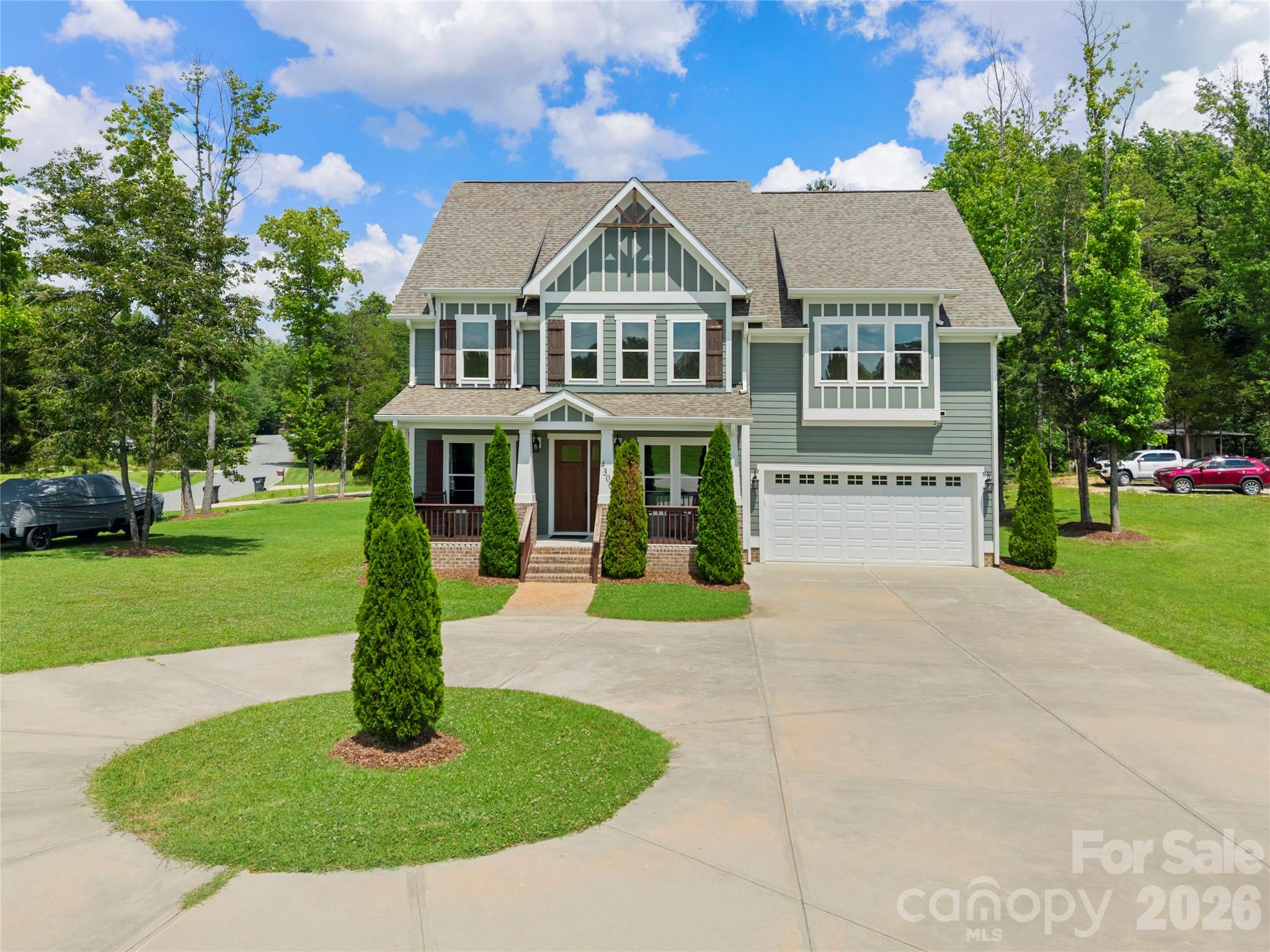 Welcome to this exceptional custom-built 5-bedroom, 3.5-bath home situated on a desirable corner lot. From the moment you arrive, you’ll appreciate the quality craftsmanship, timeless design, and attention to detail that make this home truly stand apart. A circular driveway and additional rear parking provide both convenience and outstanding curb appeal. Step inside to discover gorgeous hardwood flooring, soaring ceilings, extensive custom trim work, and luxury finishes throughout. The spacious great room is highlighted by elegant coffered ceilings and a stunning stone fireplace, creating a warm and inviting space for everyday living and entertaining.
The chef’s kitchen is designed to impress, featuring a massive center island, gas cooktop, custom hood vent, built-in wall oven and microwave, abundant cabinetry, and premium finishes throughout. The adjoining vaulted dining room offers an elegant setting for gatherings both large and small. Retreat to the main-level primary suite, complete with a tray ceiling and a luxury primary bath featuring a spacious walk-in tiled shower and upscale finishes. A generously sized laundry room is conveniently located on the main level. Built with quality that extends beyond the visible finishes, this home features upgraded 2x6 framing for enhanced strength, energy efficiency, and sound insulation, along with an encapsulated crawlspace for added peace of mind. With five spacious bedrooms, three and a half baths, and exceptional craftsmanship throughout, this home offers the perfect blend of luxury, comfort, and functionality. Every detail has been thoughtfully designed and meticulously executed, making this one-of-a-kind property an exceptional place to call home