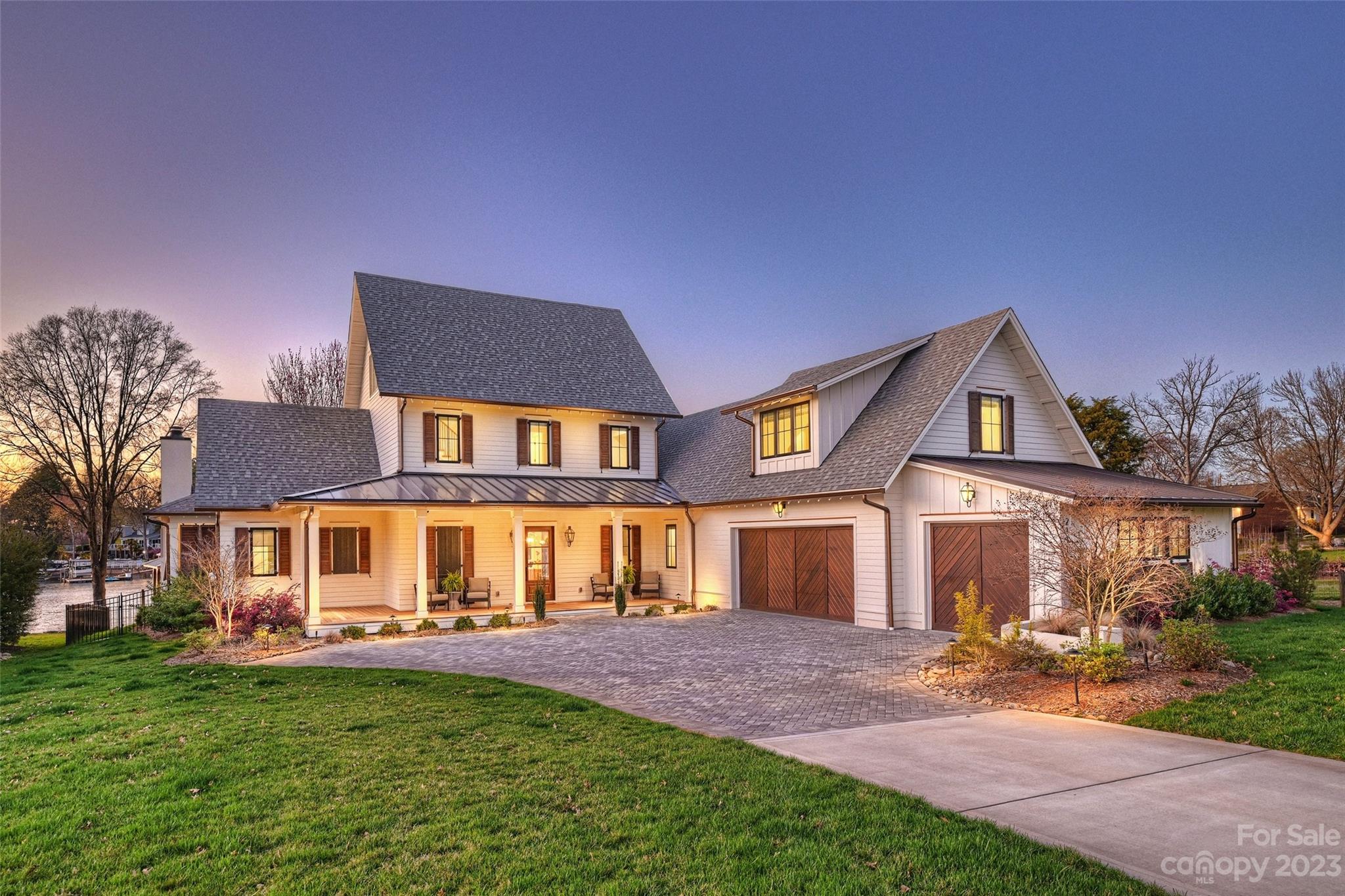 Highly-designed gently lived-in home is the most special of its kind situated on Lake Norman with the most impressive sunset views from every room. Charming and clean modern farmhouse design throughout. Entry foyer leads into the expansive and amazing living area and kitchen that features high-end appliances, walk-in scullery pantry/bar a large island with plenty of seating adjoining the spacious living area featuring a wall of windows. Living area features a fireplace flanked by beautiful built-ins, a large mantel and lake views. Split floor plan, large bonus room, and additional office or another laundry. Covered porch leads to the backyard pool with a resort-style outdoor entertaining space. Feel like you are on vacation in your own backyard, with a brand-new gunite infinity pool, travertine decking, and oversized infinity hot tub. No expense has been spared. Large three-car garage, with plenty of room for storage or an extra vehicle, oversized laundry room with abundant storage.