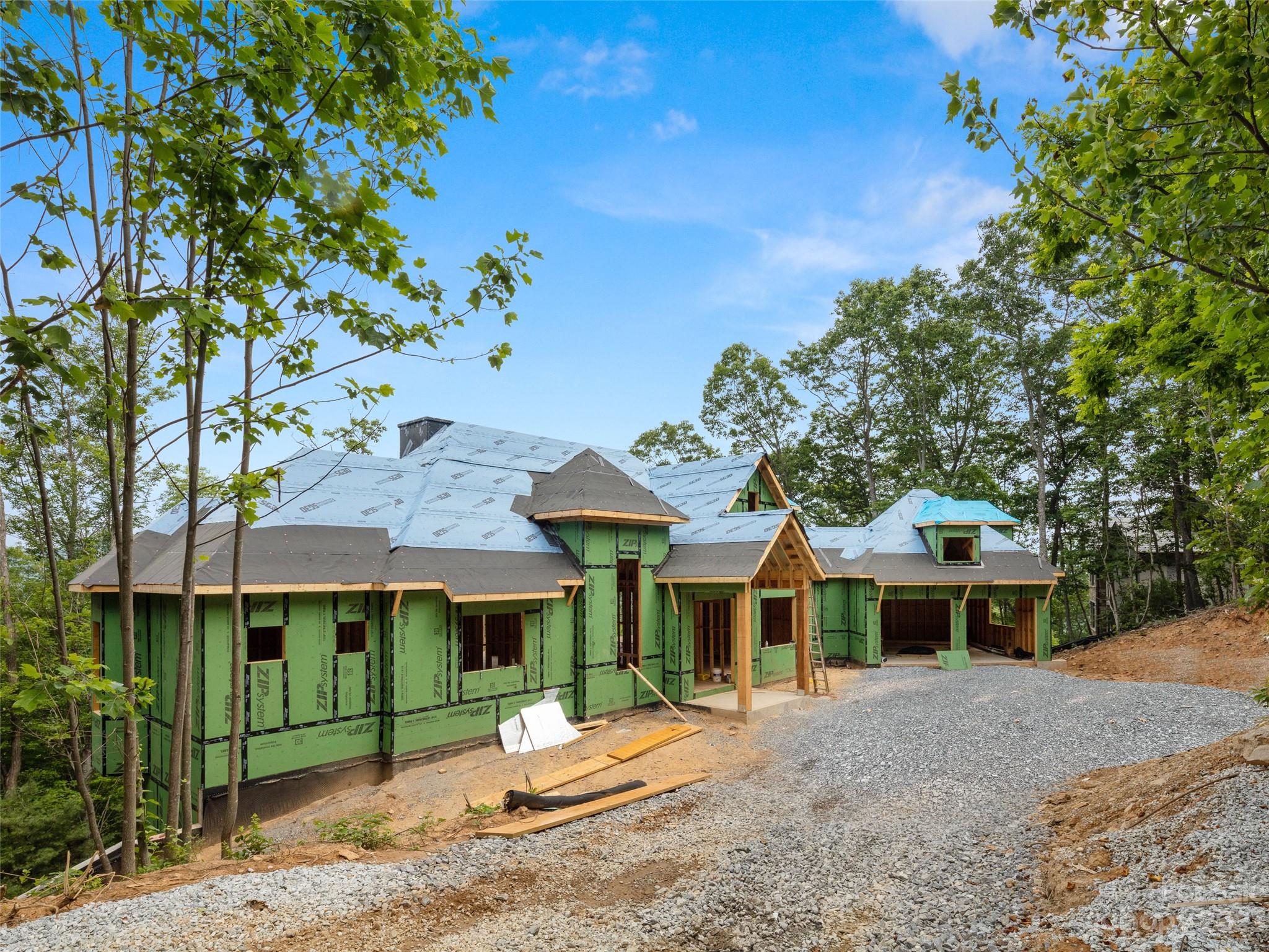 New construction overlooking Walnut Cove and the Jack Nicklaus Signature Golf Course, the only private gated golf community within 12 miles of downtown Asheville, NC. This home has Platinum Level finishes and numerous upgrades including heated storage, garage, and porches.  Many upgrades such as wood floors/posts/beams, elevator, raised kitchen ceiling, outdoor kitchen/fireplace, upgraded kitchen counters/appliances, and more!  This home is being built by American Eagle Builders to maximize the lot and the views. Must see!