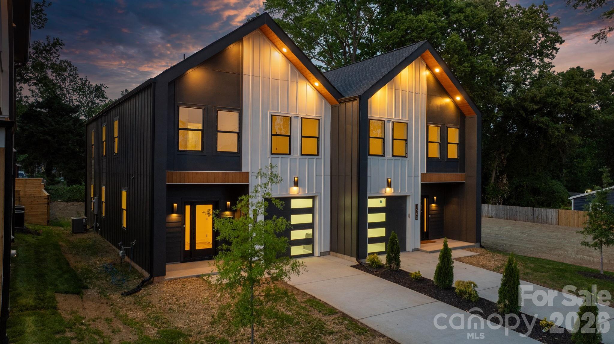Welcome to a townhome that redefines modern living in Charlotte. Built by Halo Construction in partnership with Nava Builders, this 3-bedroom, 2.5-bath home with a 1-car garage delivers a true wow factor the moment you walk in and finishes you simply don't see in townhomes at this price point. The kitchen is the showstopper. High-contrast, cabinetry pairs sleek black lowers with crisp light brown oak uppers, topped with 5-tier Panda quartz countertops chosen specifically to add dimension and depth. A custom designer tile backsplash runs to ceiling, framing a gas range and a full suite of black stainless steel appliances, including an LG InstaView refrigerator that lights up with a simple knock on the glass. Every surface in this kitchen was selected with intention, and it shows. The living area is anchored by a modern electric fireplace, finished with designer lighting throughout and a custom fabricated metal railing that brings an architectural edge to the staircase the kind of detail that elevates the entire home. Even the garage steps it up with hexagonal accent lighting, signaling right away that no space was an afterthought. Upstairs, the same intentional design carries into the bathrooms: high-end tile that flows seamlessly from the floor straight up into the shower walls, custom closet build-outs, and modern fixtures that tie everything together. On the main level, the half bath features a custom sink another small touch that sets this home apart from the typical new build. Behind the scenes, the home is built to perform: gas furnace, gas range, and an electric water heater efficient, modern, and ready for the long haul. Location is everything, and this one delivers. You're 5 minutes from Camp North End, less than 10 minutes to Uptown and South End, close enough to enjoy the best of Charlotte, far enough out to skip the rush hour grind. You're also surrounded by luxury residential properties, including an estate-level home right next door, so the long-term value of this street speaks for itself. For buyers thinking about multi-generational living or an in-law setup, the full duplex is available a rare opportunity to keep family close without sacrificing privacy. This townhome doesn't ask you to compromise. Schedule your private showing today.