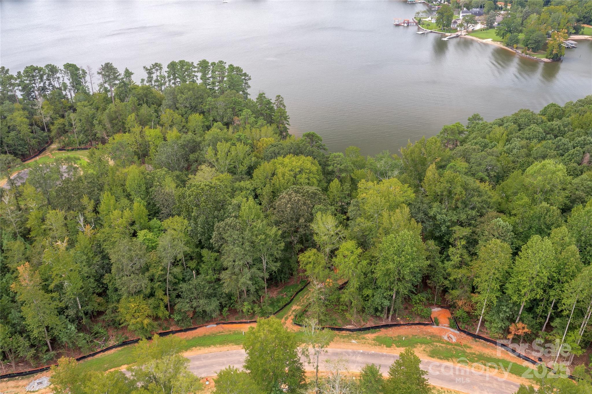Live the lake life in a new custom-built waterfront home! Homesite 8 in South Carolina features a huge beach and elevated land for your boat dock. Perfect homesite for a basement floor plan. Enjoy south and west lake views from your home & your own sandy beach on Lake Wylie. Build your custom home and add a dock for your lake toys. Add a pool for even more fun. Located in South Carolina but on the border with North Carolina on land that Daniel Stowe owned years ago. This location provides southern views with western perspective on the right side. Buy this homesite and choose when to build with one of McLean's approved builders - no time limit in which to start construction of your home. McLean features a clubhouse, outdoor pool, fitness center, walking trails. The Carolina Thread Trail and Daniel Stowe Botanical Garden are a minute away. Quaint city of Belmont is 10 minutes away with restaurants and city park. Shopping is five minutes away in Lake Wylie. Come take a look!