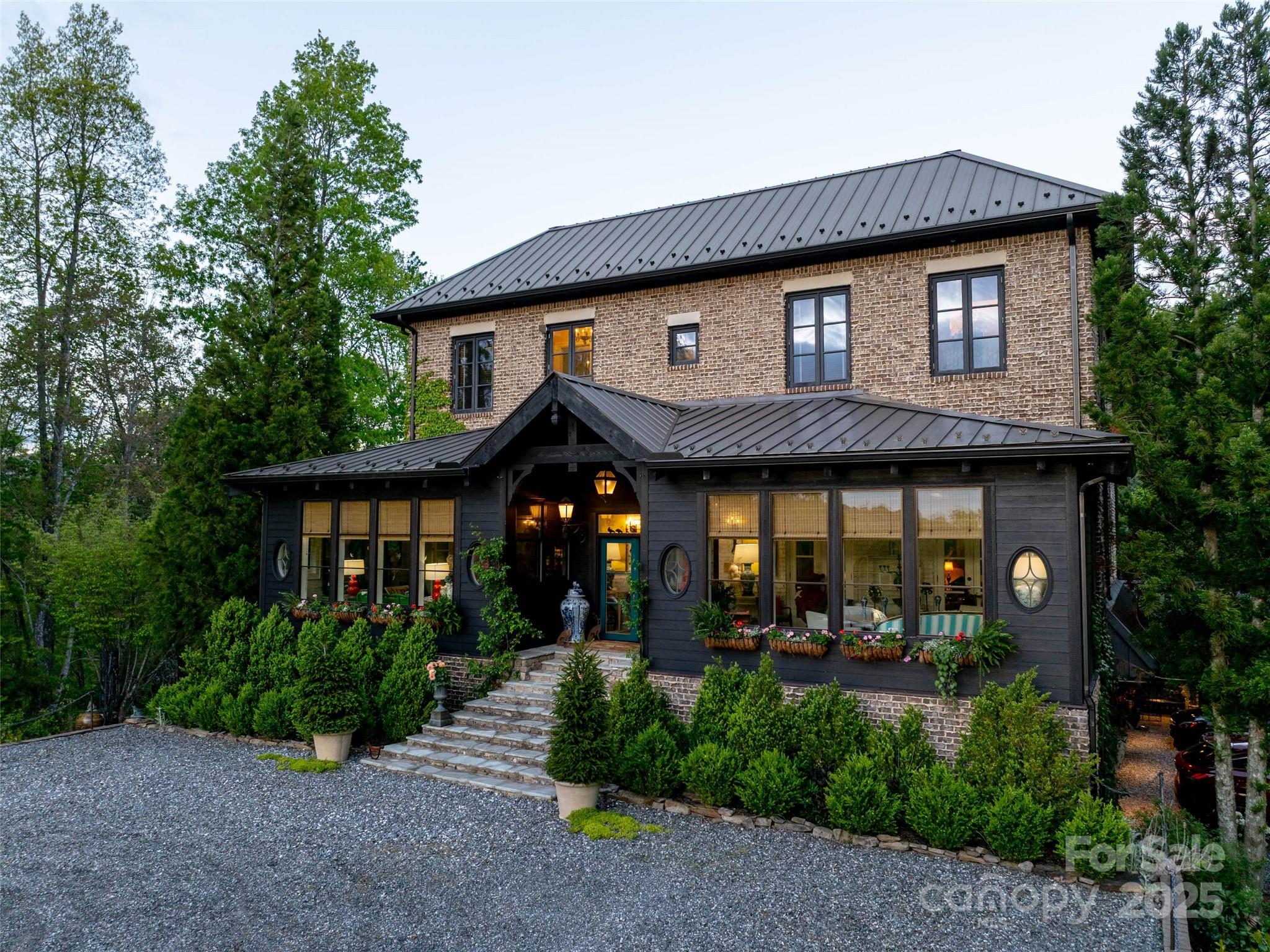 Carlin Manor is an exquisite estate, 17+ acres w/ sweeping, long-range views of Wolf Lake. Curated elegance, w/ lush gardens, sculpted landscaping, & timeless architecture. Designed for grand entertaining & quiet repose, featuring multiple sitting rooms & sunrooms, w/ breathtaking vistas. Rich marble, tile, & hardwood flooring throughout the home, complement the refined aesthetic at every turn. A chef’s kitchen of exceptional quality, a Wolf gas range, & generous center island ideal for culinary artistry & casual gatherings. A grand dining room for memorable occasions, spa-like baths w/ clawfoot tubs & marble vanities evoke timeless European charm. French doors lead to an outdoor terrace, a pergola & dedicated al fresco dining space suited for evening soirees. Every detail thoughtfully considered from the distinctive bark and brick exterior to the bespoke lighting, artisanal hardware, and inviting fireplaces that encourage conversation and quiet reflection throughout the home.