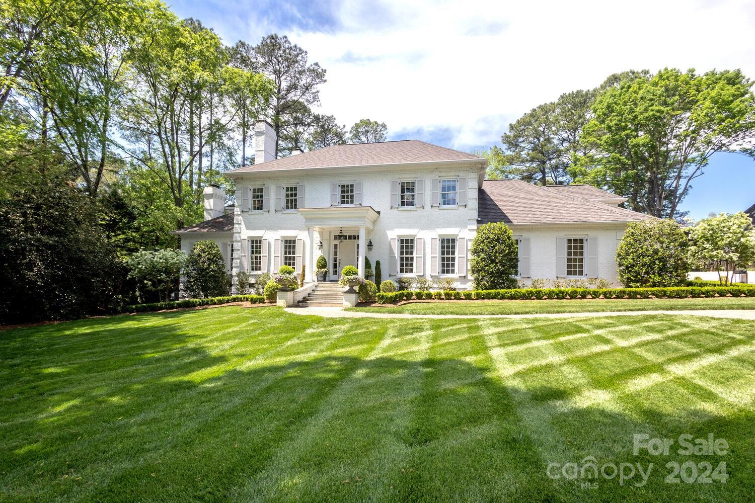 Beautiful traditional brick home privately situated on the 14th tee of Quail Hollow. The spacious foyer welcomes you into the home with formal living & dining rooms on the main level. An open kitchen & great room lead to the back patio overlooking the salt water pool w/spa -- that features a new self cleaning technology, screened porch & immaculate landscaping. This home is perfect for entertaining! The main level bedroom is a private guest-suite w/ potential to be converted to a secondary primary suite. Upstairs the owners bedroom provides a relaxing retreat, featuring a fireplace, large windows overlooking the backyard, spacious walk-in closet & bathroom. Each of the 3 additional bedrooms upstairs feature ensuite baths. Several bonus spaces throughout the home can be used for play areas or added closets/storage. The sellers installed a whole home generator as one of the many improvements to the property. A wonderful opportunity to be in highly sought-after Quail Hollow neighborhood!