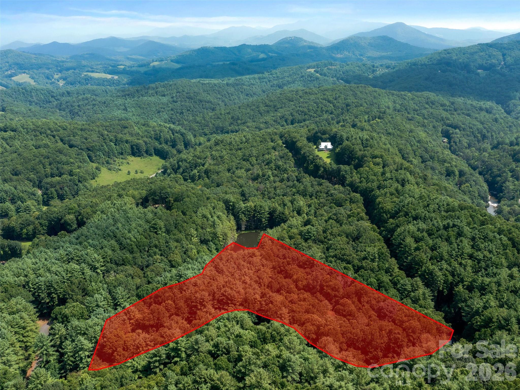 Discover 6.29 acres of pristine mountain land in Rivers Edge Subdivision, awaiting your dream home. Nestled against the hillside that borders a private pond, this property provides both tranquility and recreational potential.