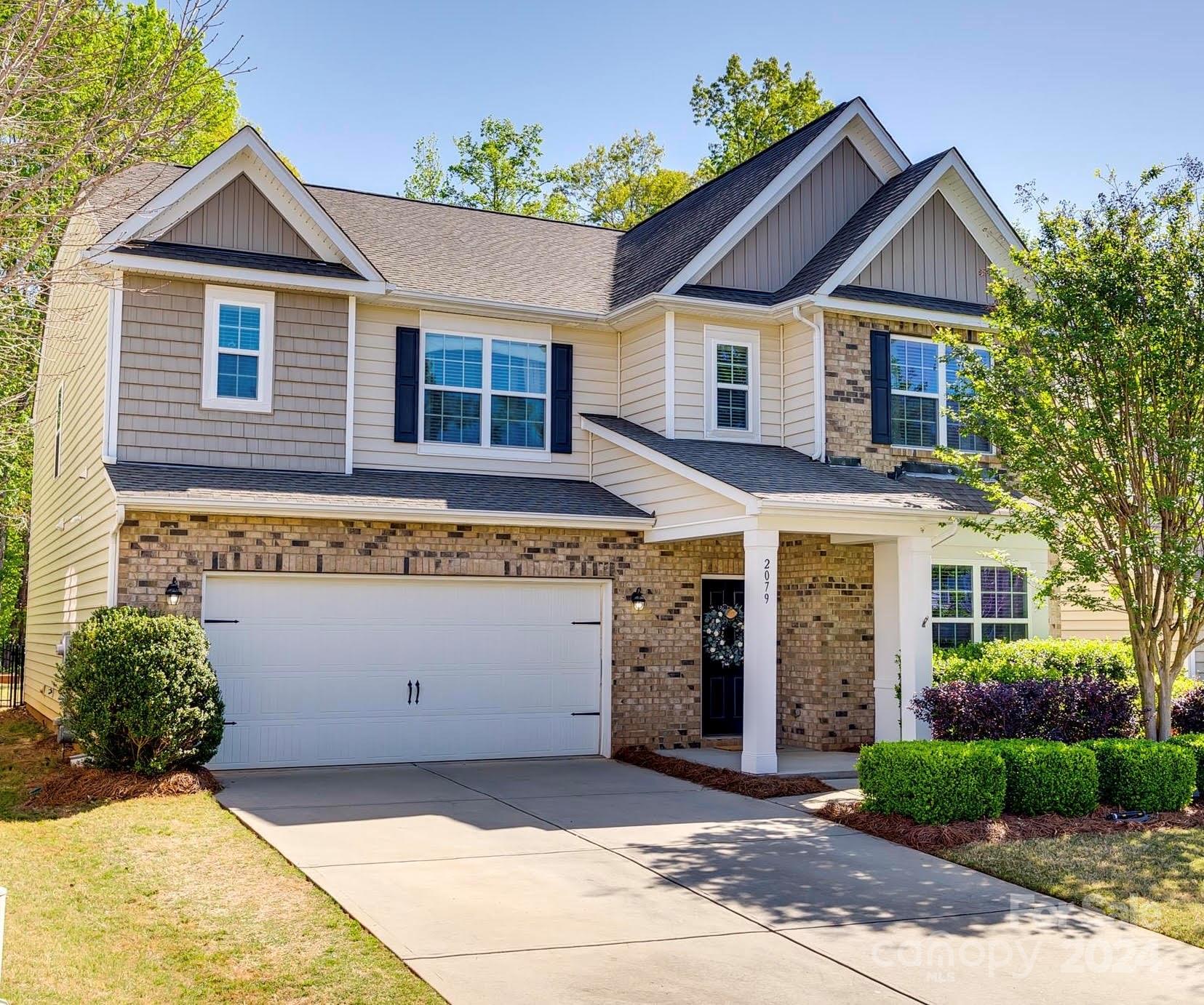 Welcome home to Carolina Reserve! This inviting Grisham model boasts an open layout, updated wood floors, and new carpet! The first level features a private office, formal dining room, breakfast area, & an open kitchen with granite counters, ample cabinet space, and SS appliances. The great room is the perfect space to gather, with beautiful built-ins and a gas fireplace. The guest suite on the main floor has a full private bath and a walk-in shower. Upstairs, you will be greeted by a spacious loft and 4 additional large bedrooms, each with walk-in closets & direct access to a bathroom. The laundry room completes the second level.  Step outside to the expansive stamped concrete patio where your private, fenced & level backyard overlooks the woods. The shed provides additional storage or hobby space. Updated HVAC (2021) and water heater (2023), both with warranty.  Neighborhood amenities include a pool, clubhouse, fitness center, playground, dog park, pond, and walking trails.
