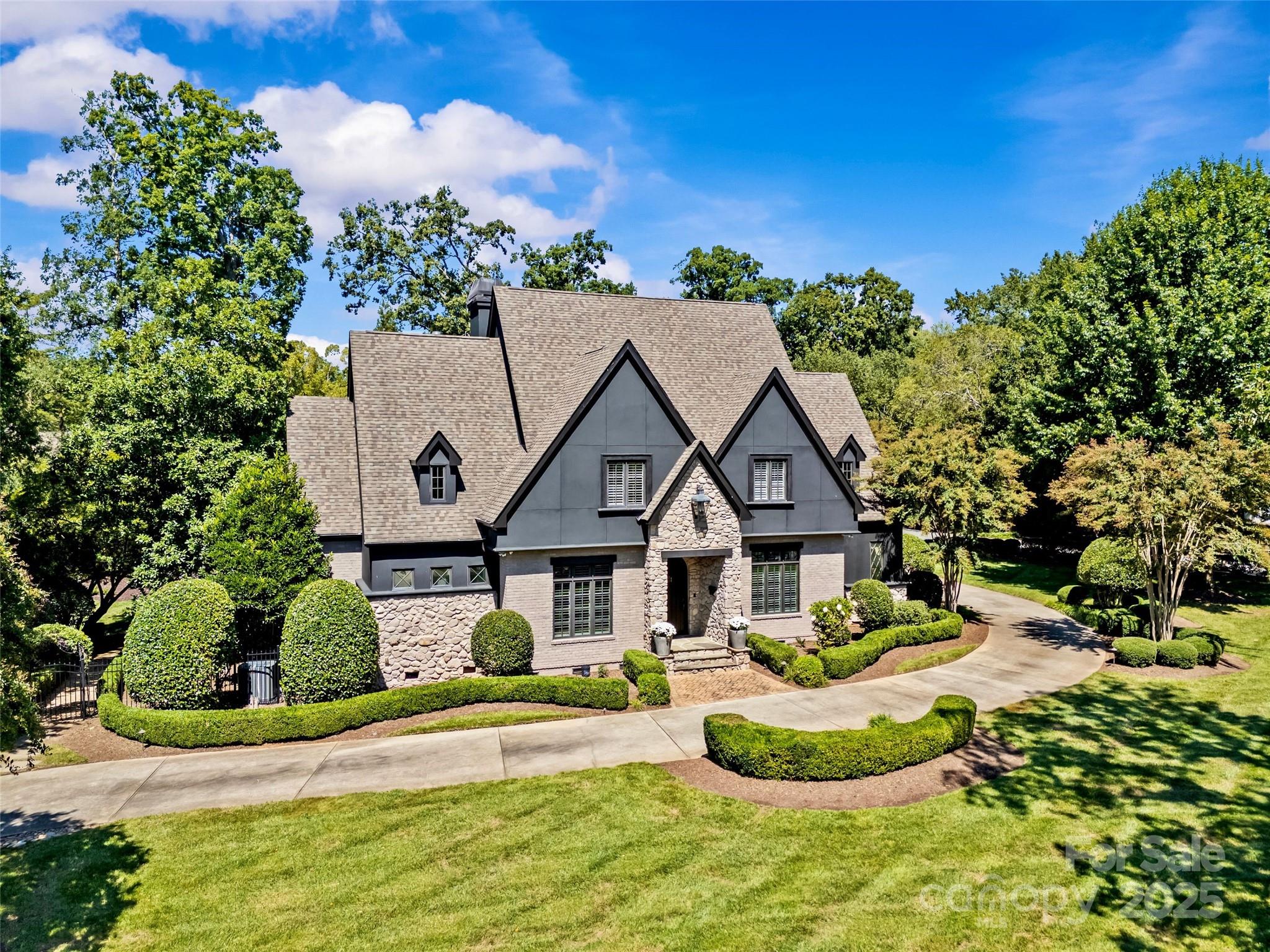 Exceptional Old Foxcroft home situated on a rare, immensely private .89-acre corner lot with over 6,500 sq/ft of refined living space! This renovated 5BR/5.5BA residence wows at every turn with soaring ceilings, gleaming hardwoods and high-end finishes throughout. The chef’s kitchen features white quartz counters, dual oversized islands, Wolf range, paneled refrigerator/freezer, two dishwashers, and walk-in pantry. Expansive living spaces include the dramatic vaulted sitting room with  stone fireplace, family room with French doors to the covered porch, formal dining, and private study. The main-level primary suite offers vaulted ceilings, automatic black out shades, custom walk-in closet, and spa-like bath with soaking tub and oversized shower. Upstairs includes a rec room with fireplace and four bedrooms with en-suite bath access (bedroom 5 flexes as an add'l bonus). Unparalleled outdoor living impresses with a heated saltwater pool/spa, covered porch with heaters, outdoor kitchen, and built-in stone fireplace. The stunning pool house is a one of a kind entertainer's dream and boasts oversized dramatic doors with limestone detail, sealed concrete floors, an incredible wrap-around wet bar, wine room, and full bath! A finished workshop and attached 3-car garage with epoxy flooring complete this incredible property. Just minutes from SouthPark and Uptown this is luxury living at its finest in an unbeatable location!