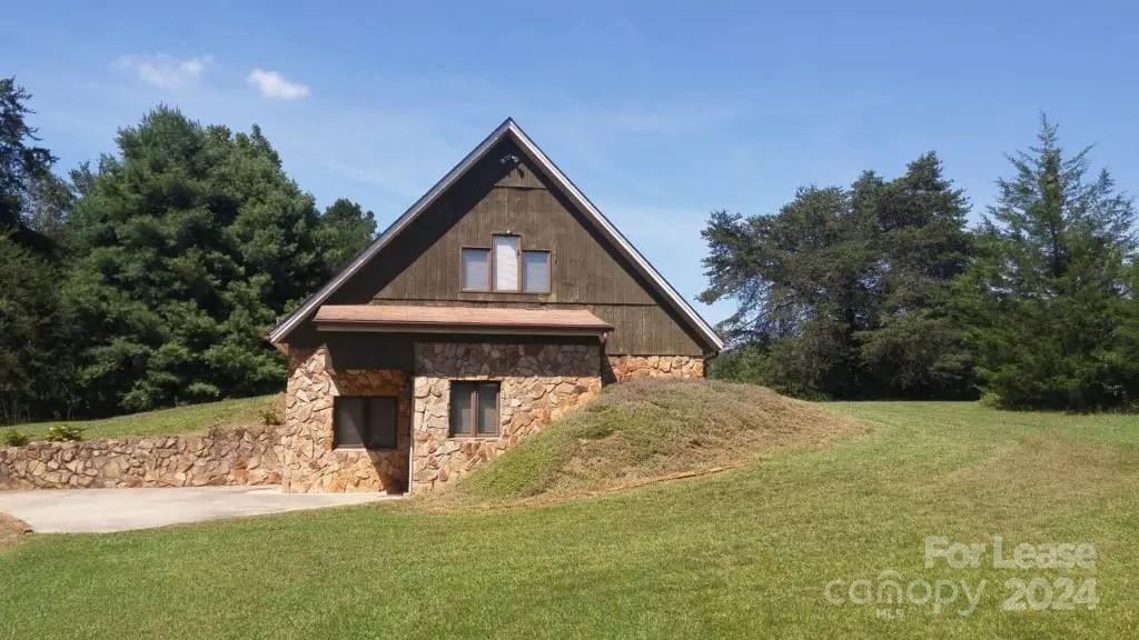 This 3 bedroom, 2 bathroom A-frame house offers a large living room, kitchen with appliances, dining area, full bath and bedroom on the main level. There are two bedrooms and a full bath on the upper level. This house is designed to reduce energy consumption by using the surrounding land as natural insulation while skylights throughout supply plenty of natural light. The property is very private, updated and ready to move in, also has a large outbuilding for storage. Tenant is expected to maintain lawn, and responsible for all utilities.
