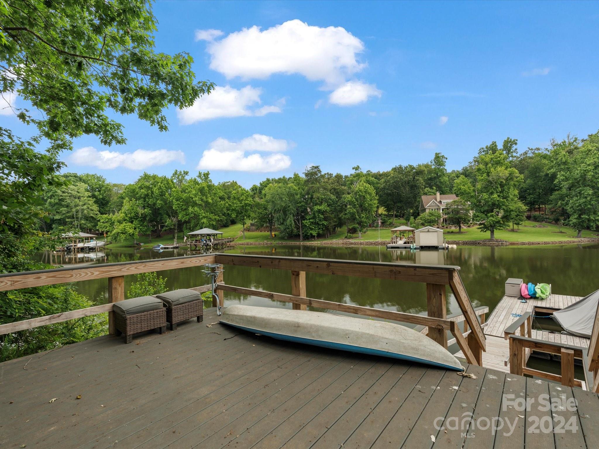 Lakeside Living on Lake Wylie! Sleek kitchen with stainless steel appliances, quartz countertops, and a 7 ft pop-out window leading to an outdoor bar for year-round entertaining against the lake backdrop. Cozy living room with a gas fireplace and luxury vinyl plank flooring added in 2022 throughout the home. The primary bathroom is surrounded in gorgeous tile and luxury fixtures with a huge walk-in shower and freestanding tub combo. Train HVAC system added in 2022 gives you peace of mind for years to come.  Fully finished walk-out basement with a kitchenette, 2 bedrooms, flex space and laundry room with washer/dryer included. This home offers true outdoor retreat with a 1500 sq ft wrap-around porch, multiple decks, firepit, and a private dock for enjoying panoramic lake views. More than a home, it's a lifestyle. The lifestyle you've always dreamed of! Schedule a showing today!