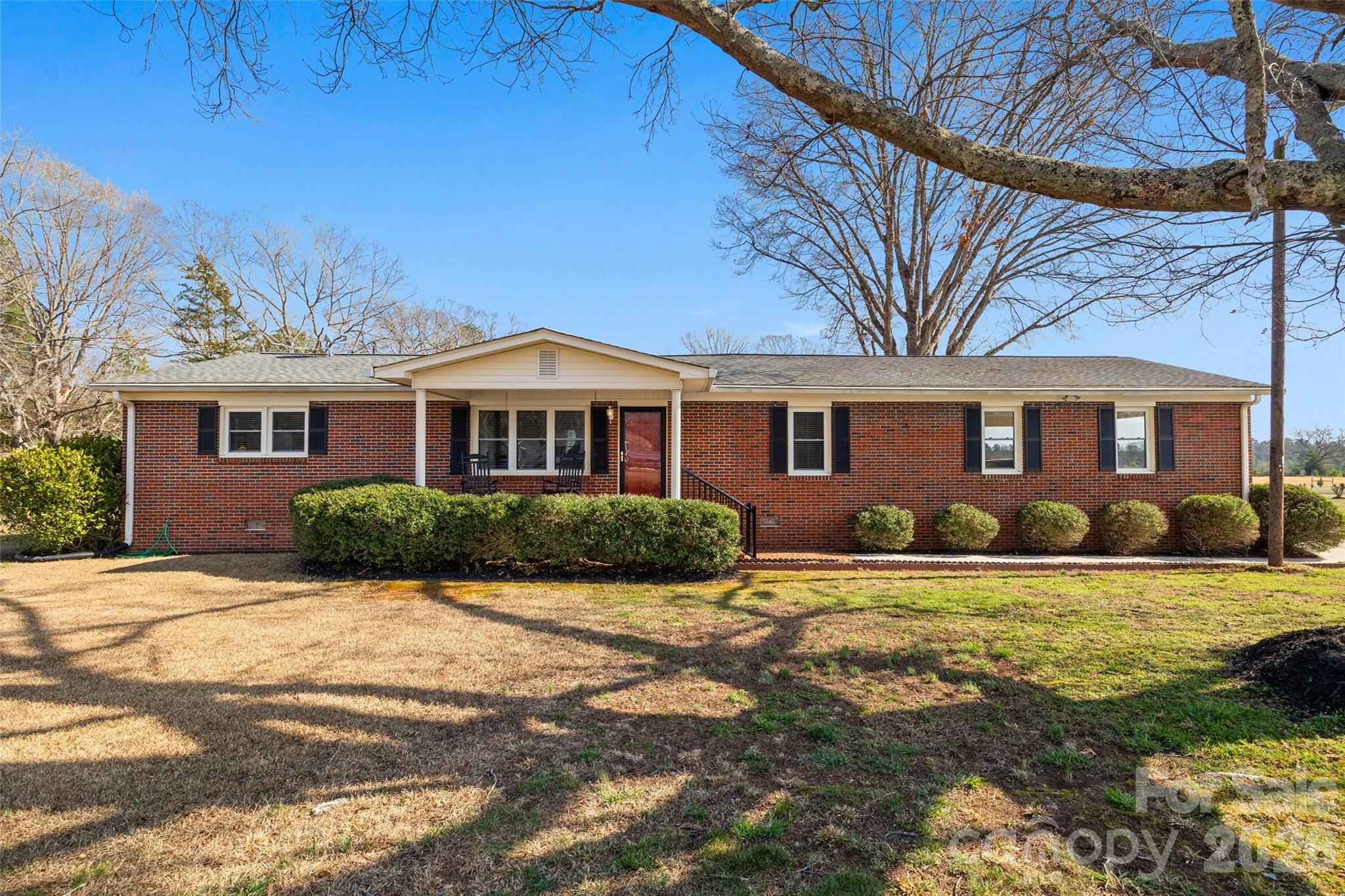 Enjoy country living with room to spread out! This well-maintained full brick home sits on over an acre and features a large fenced backyard, perfect for pets, gardening, or simply enjoying the peaceful setting. The home offers 3 bedrooms and 1.5 baths, along with a comfortable living room featuring a fireplace. Additional highlights include a separate laundry room, on-demand water heater, and a two-car carport for convenient covered parking. Relax on the front or back porch and take in the quiet surroundings while still being within easy reach of town. Solid construction, spacious yard, and a great country setting make this property a wonderful place to call home.