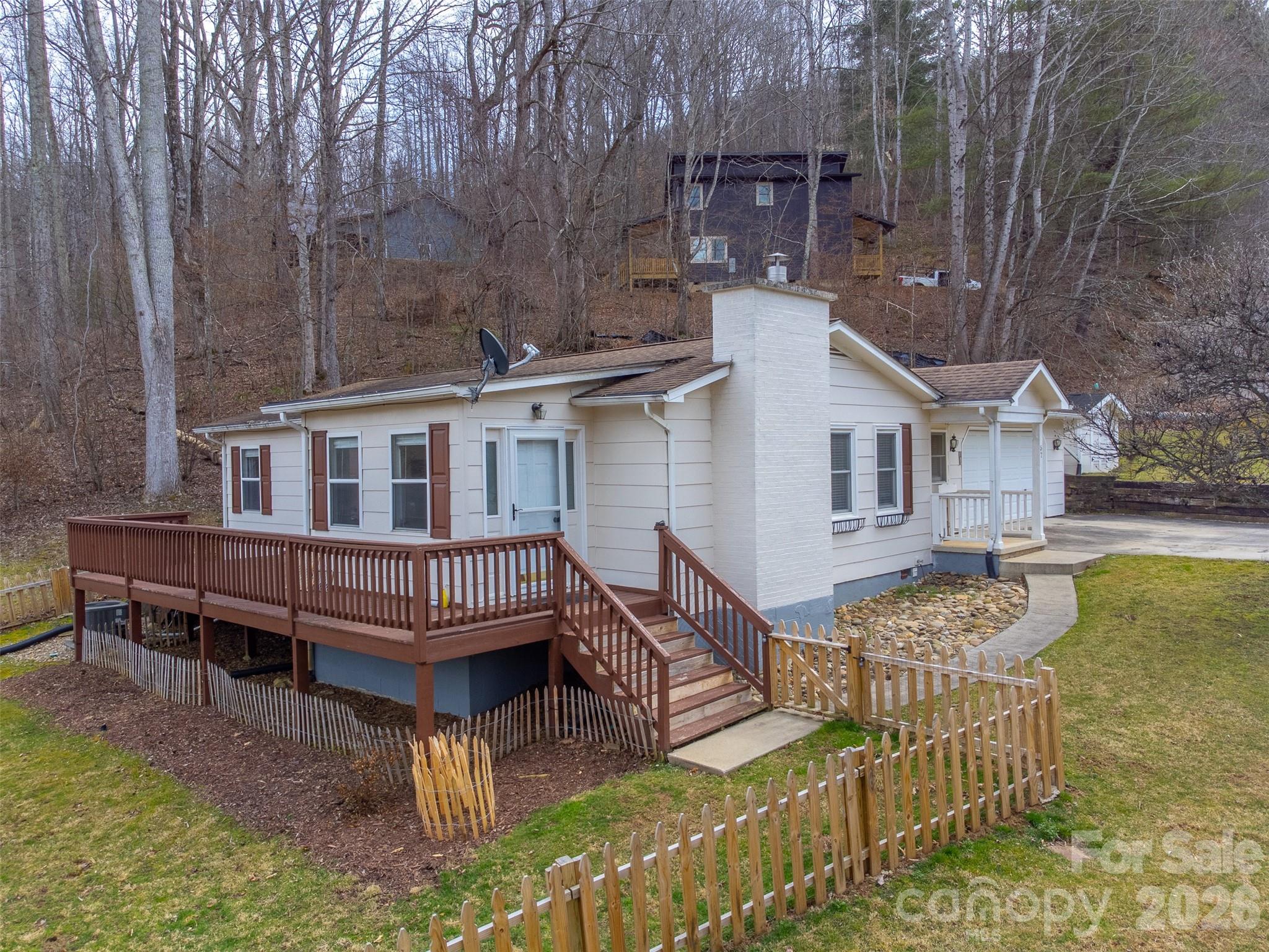 Welcome to 57 Melody Lane in Maggie Valley, North Carolina, a charming mountain home offering the convenience of all on one level living. Filled with natural light, the home features large windows that create a bright and welcoming atmosphere throughout. This home also includes a new handicap-accessible shower, providing added comfort and accessibility. The thoughtful layout makes it ideal for those looking for easy living, whether as a full-time residence, vacation getaway, or investment property. Located in the heart of Maggie Valley, you’ll enjoy peaceful mountain surroundings while still being close to local dining, shops, outdoor recreation, and scenic drives along the Blue Ridge Parkway.