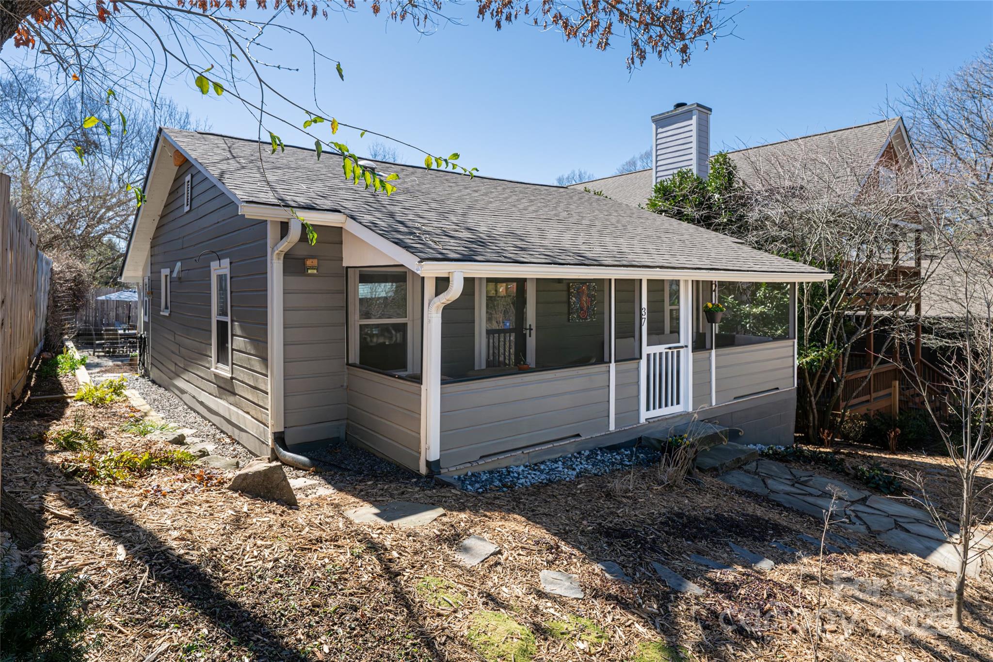 Nestled in the heart of Asheville, this Montford gem sits on a quiet street, a short stroll from Tall John’s and Nine Mile and All Day Darling. Step into this beautifully renovated bungalow beaming with historic charm and thoughtful upgrades. A full kitchen renovation, a serene screened porch, and an inviting patio make entertaining effortless. Situated on a hidden street off Pearson, adjacent to the Historic District, this property is a private and tranquil escape, yet a walk to downtown Asheville's best eateries, parks, and arts scene. This property offers the unique advantage of a double frontage lot, providing dual street access. It features a two-car driveway and additional street parking at the front, ensuring ample parking options for residents and guests. The perennial gardens, raised beds, and fenced yard invite both relaxation a sense of solitude and connection to nature. If you appreciate character, craftsmanship, and beauty , 37 Gray Street will capture your heart.