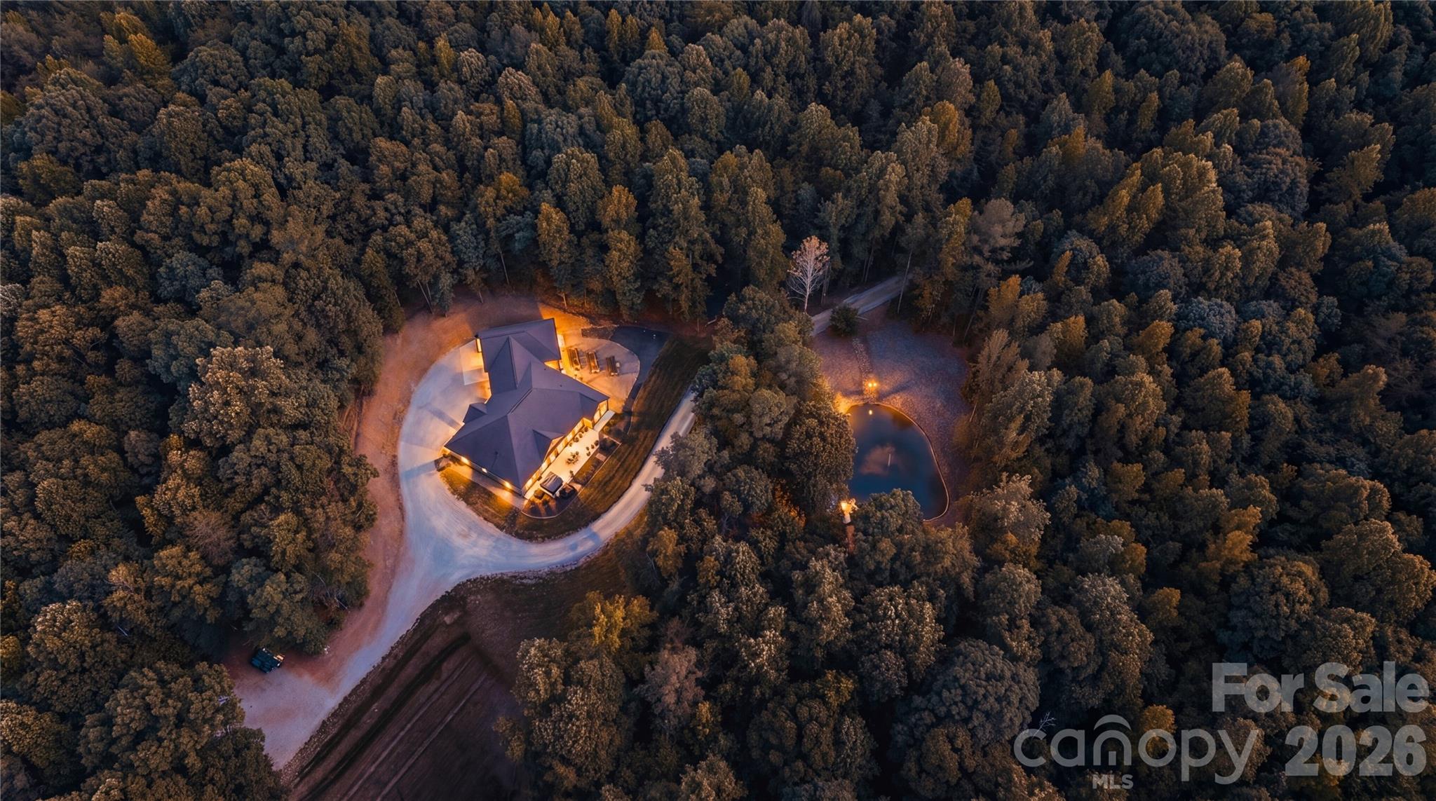 Imagine pulling up to your own private gated entrance and instantly feeling that deep sense of “I’m finally home.” This stunning property sits on over 19 acres of peaceful, tree lined privacy, and delivers everything you’ve been dreaming of and more!

The moment you step inside, you’re greeted by an impressive foyer that flows into a warm, open concept living space. Soaring vaulted ceilings and a cozy fireplace in the living room set the tone for relaxed evenings and unforgettable gatherings. 

The oversized gourmet kitchen is an absolute showstopper and is loaded with high-end KitchenAid appliances, a massive breakfast bar, incredible prep space, a huge walk-through pantry, and a dedicated coffee bar that’s perfect for lazy mornings or entertaining guests. 

Just off the kitchen, the sun drenched three season room with its own fireplace feels like your personal sanctuary. Picture yourself curled up with a book, watching the sunlight dance through the trees, or stepping out onto the expansive patio overlooking your private pond, fire pit, and garden. This is where memories will be made.

The thoughtfully designed split-bedroom layout gives everyone their own space. The primary suite is pure luxury vaulted ceilings, a spa-like ensuite with his-and-hers sinks and a beautifully tiled shower, plus a massive walk-in closet that leads into an exceptionally functional laundry room. Complete with storage galore, a laundry sink, and folding counter. 

On the other side of the home, you’ll find a large bedroom with its own full bathroom that is ideal for guests or as a second primary ensuite. Two additional bedrooms share another full bath, and one includes a charming loft that’s included in the sale. 

A spacious office with built-in desks and a half bath offers the perfect work-from-home setup, with convenient access to the two-car garage. The garage is complete with extra bump-out space perfect for a home gym or additional storage.

But the real wow factor? Your completely separate barn/venue. This is pure entertainment magic. Huge sliding barn doors open to a massive event space with its own full kitchen and bathroom that is perfect for weddings, parties, holiday gatherings, or whatever your heart desires. 

Upstairs you’ll find over 750 square feet of storage, a cupola that fills the space with natural light, and a fully finished one bedroom apartment with its own private back porch overlooking the pond. This is the ultimate bonus space most people only dream about this isn’t just a house, it’s a lifestyle. Privacy, luxury, and ready for you to move in and start living your best life immediately. Homes like this don’t come along often. Don’t wait, schedule your showing today and make this extraordinary property yours before someone else does.