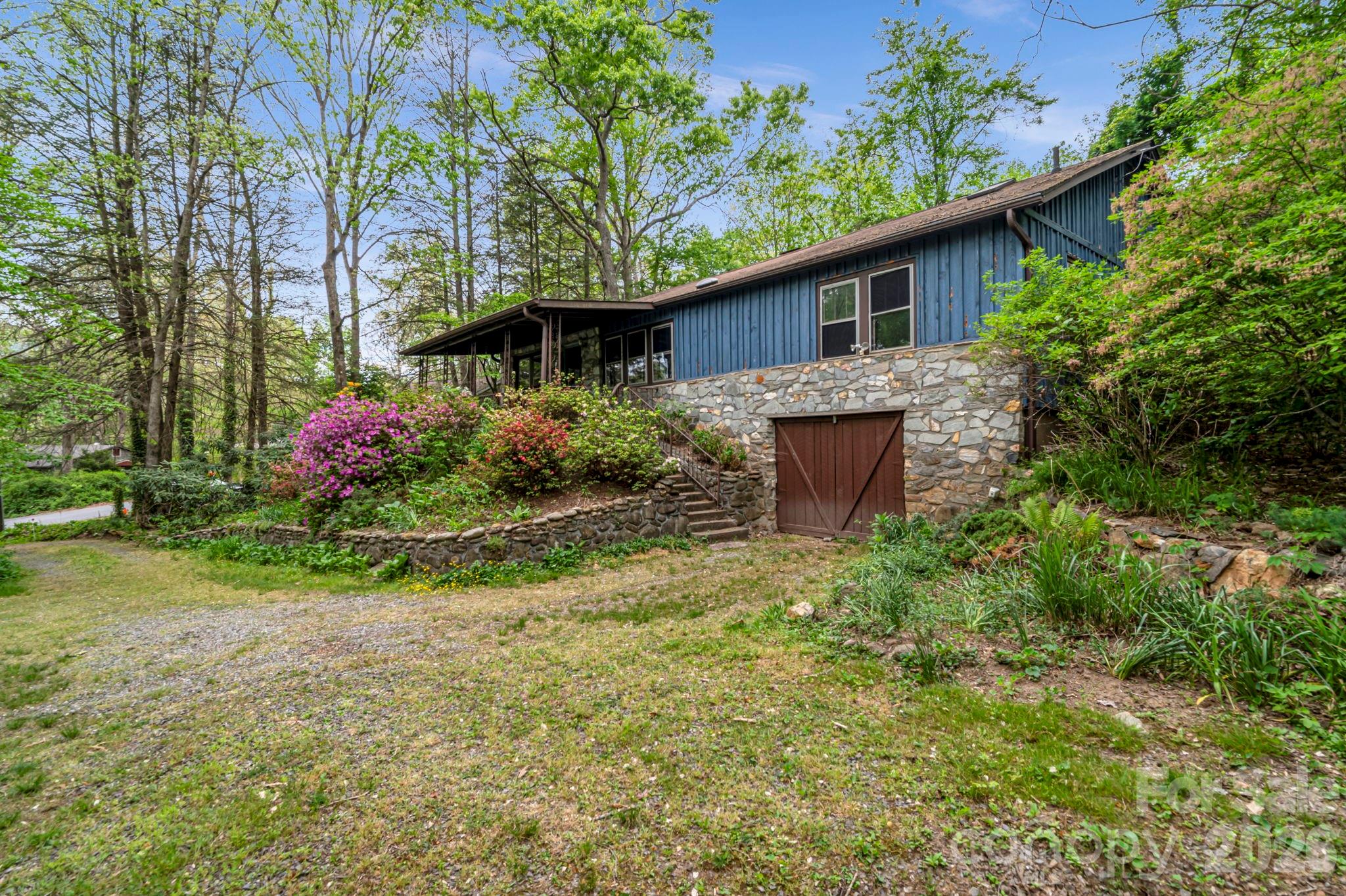 Come make this charming mountain home your own! The home sits tucked back among the trees in Ridgecrest, a private and peaceful neighborhood that's still convenient to Old 70 and I-40, just a 5 minute drive from downtown Black Mountain and a 25 minute drive from downtown Asheville.

The cabin features beautiful wormy chestnut throughout, tongue and groove pine walls, wild cherry wood floors, and a large stone fireplace with wood-burning heat. The floor plan is spacious and roomy with larger closets than you'd expect from a mountain cabin built in 1945, and features storage space throughout with some cedar lined closets!

The formal dining room can easily serve as a 4th bedroom with the simple addition of a door placed in the doorframe leading to the kitchen or it could stay a formal dining room as previously used. The attic offers 7-foot clearance down the center and could potentially be converted into finished heated living space for a buyer with the right vision. The tall crawlspace even has room to store a compact car behind the lower-level garage door. Mature rhododendron terraced landscaping is ready to be vibrant again with a little TLC.

On Ridgecrest water which was one of the first systems to have clean drinking water restored after Helene. The neighborhood sits at a slight elevation above nearby downtown Black Mountain and the property was untouched by Helene's impacts.

Come make this your very own mountain retreat!

*Executor of the Estate makes no representations pertaining to the condition of the property and has never lived in the home.*