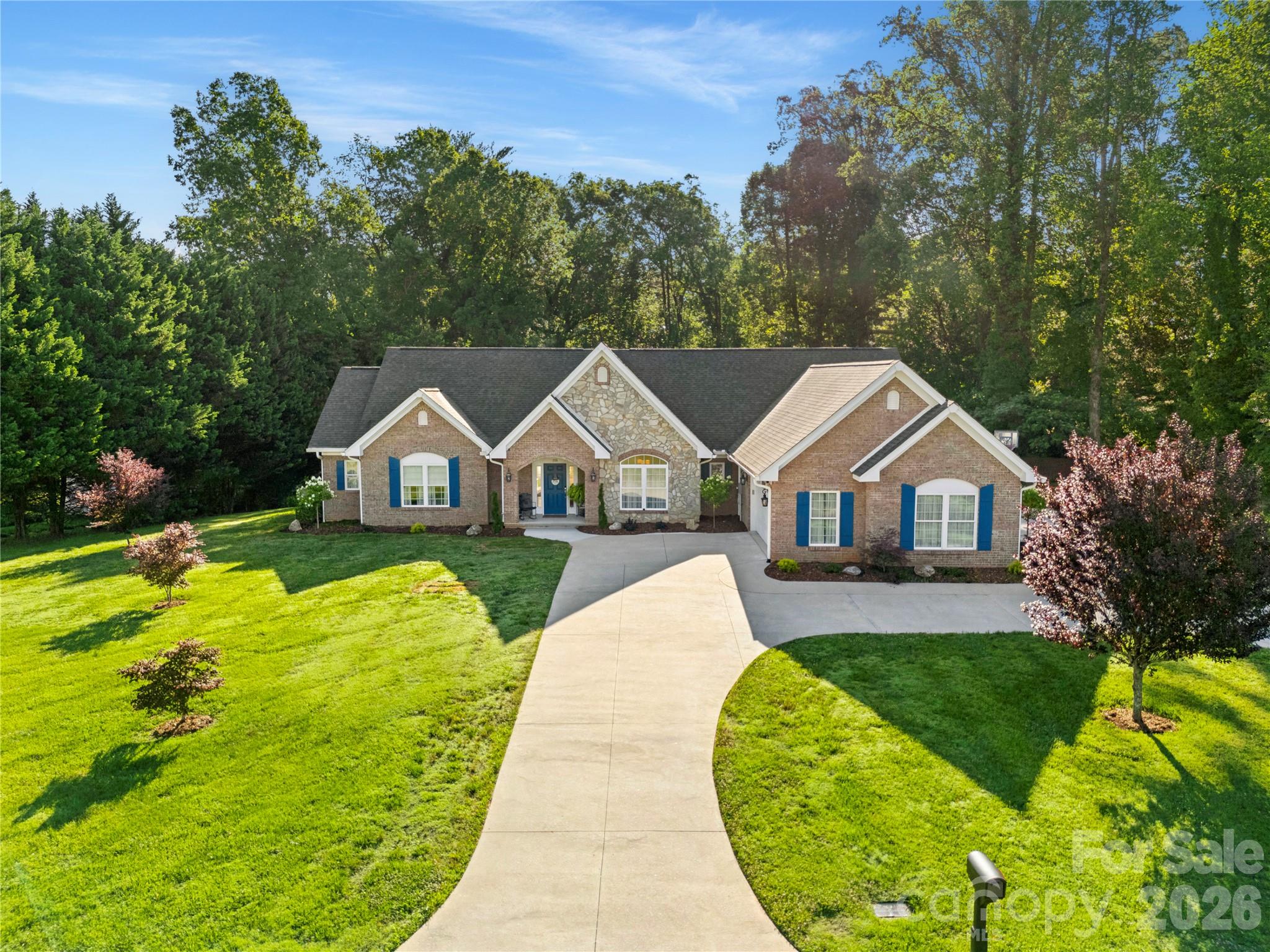 Experience refined living in one of Morganton's most sought-after locations overlooking the prestigious Mimosa Hills Golf Club. Situated on a beautifully landscaped 1.25-acre lot, this exceptional single-level executive residence offers the perfect blend of elegance, comfort, and privacy.
Designed with a highly desirable split-bedroom floor plan, the home features soaring 9-foot ceilings throughout and an abundance of natural light. The spacious primary suite serves as a private retreat, complete with a luxurious custom walk-in closet and direct access to the expansive rear deck and hot tub, creating the perfect place to unwind after a day on the course.
The heart of the home is the inviting great room featuring a fireplace and walls of glass that showcase peaceful backyard views. The great room flows seamlessly into the formal dining area, well-appointed kitchen, and sunny breakfast room, creating an ideal setting for both entertaining and everyday living.
Two generously sized guest bedrooms, each with walk-in closets, are thoughtfully positioned on the opposite side of the home. A full bath and convenient half bath provide comfort and privacy for family and guests alike. The oversized laundry room offers abundant cabinetry and storage space.
Outdoor living is equally impressive with a large rear deck overlooking the private backyard and hot tub. A private door from the primary suite opens directly to this outdoor retreat, allowing you to enjoy peaceful mornings and relaxing evenings beneath the stars.
One of the property's most remarkable features is its location directly across from the renowned Mimosa Hills Golf Club. From the front of the home, enjoy views of the picturesque 16th green and the challenging 17th par-3 hole, with stunning views of Table Rock Mountain and the Blue Ridge Mountains beyond.
Mimosa Hills Golf Club is a private, full-service membership club anchored by a legendary Donald Ross-designed golf course, first-class dining, social amenities, and a well-appointed pro shop. Designed in 1929, the course takes full advantage of Morganton's rolling landscape and spectacular mountain scenery. Donald Ross, the famed Scottish-born architect responsible for some of America's most celebrated golf courses, carefully crafted Mimosa Hills to showcase the area's natural beauty and phenomenal panoramic Blue Ridge Mountain views. Consistently ranked among North Carolina's top golf courses and recognized as one of the premier golf facilities in the Carolinas, Mimosa Hills offers an old-style layout rich in character and strategic design.
The club's distinguished history includes hosting numerous prestigious tournaments and qualifying events, including U.S. Open Sectional Qualifying, U.S. Amateur Qualifying, the Carolinas Open, North Carolina Men's and Women's Amateur Championships, North Carolina Boys and Girls Junior Championships, the Carolinas Junior Championship, NC Women's Senior Championship, the Carolinas Mid-Am Championship, and the United States Hickory Open.
Additional highlights include a rare four-car garage, generous storage throughout, and a premier location just minutes from downtown Morganton, shopping, dining, healthcare, and outdoor recreation.
This is a rare opportunity to own an executive residence that combines luxury single-level living, exceptional mountain views, golf course prestige, and an unmatched location overlooking one of North Carolina's most historic and celebrated golf clubs.