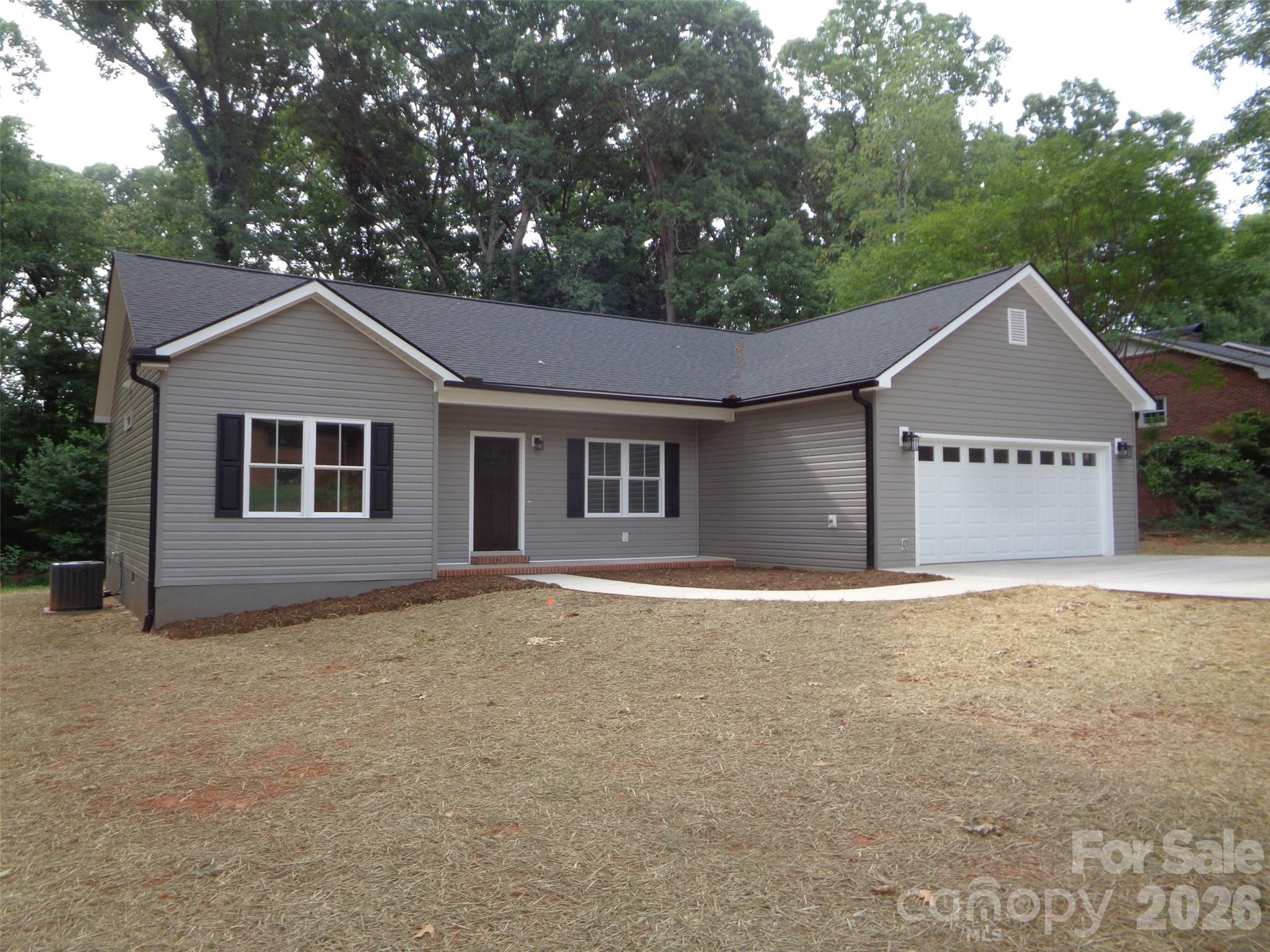 Introducing this new ranch-style home offering a comfortable level of single-level living on an in-town street with towering trees. This modern ranch features an open-concept layout with split bedrooms, large windows providing natural light, vaulted ceiling, and premium finishes throughout. The kitchen features granite countertops, tile backsplash, island and appliances. The primary suite includes a luxurious bath with walk-in tile shower and dual vanities. A spacious customized walk in closet features a built-in ironing board. Two additional bedrooms also have customized closets. The rear deck provides an excellent area to cookout or just relax.